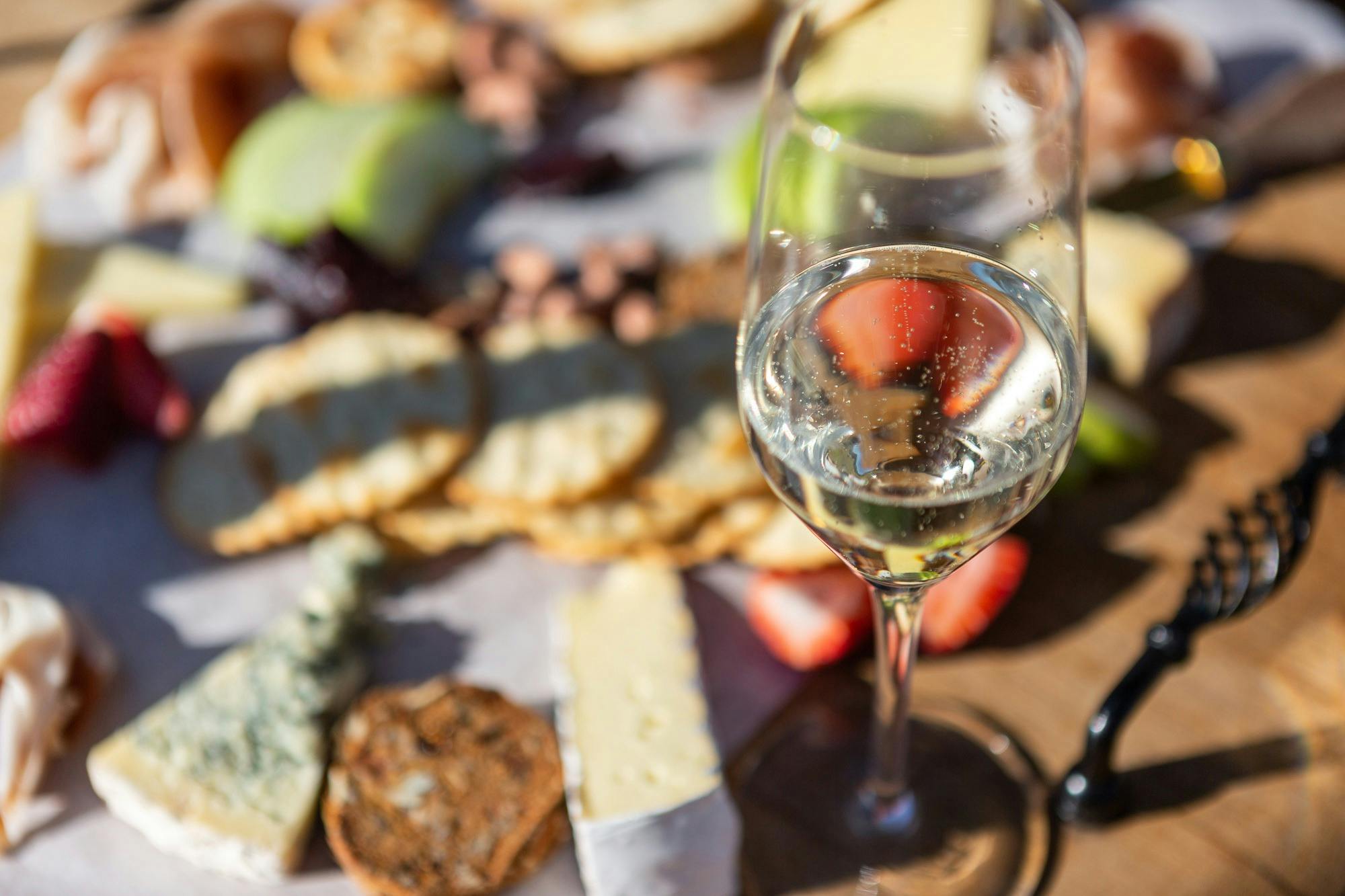 Enjoy a tasty Charcuterie board with a selection of meats, cheese and a variety of trimmings