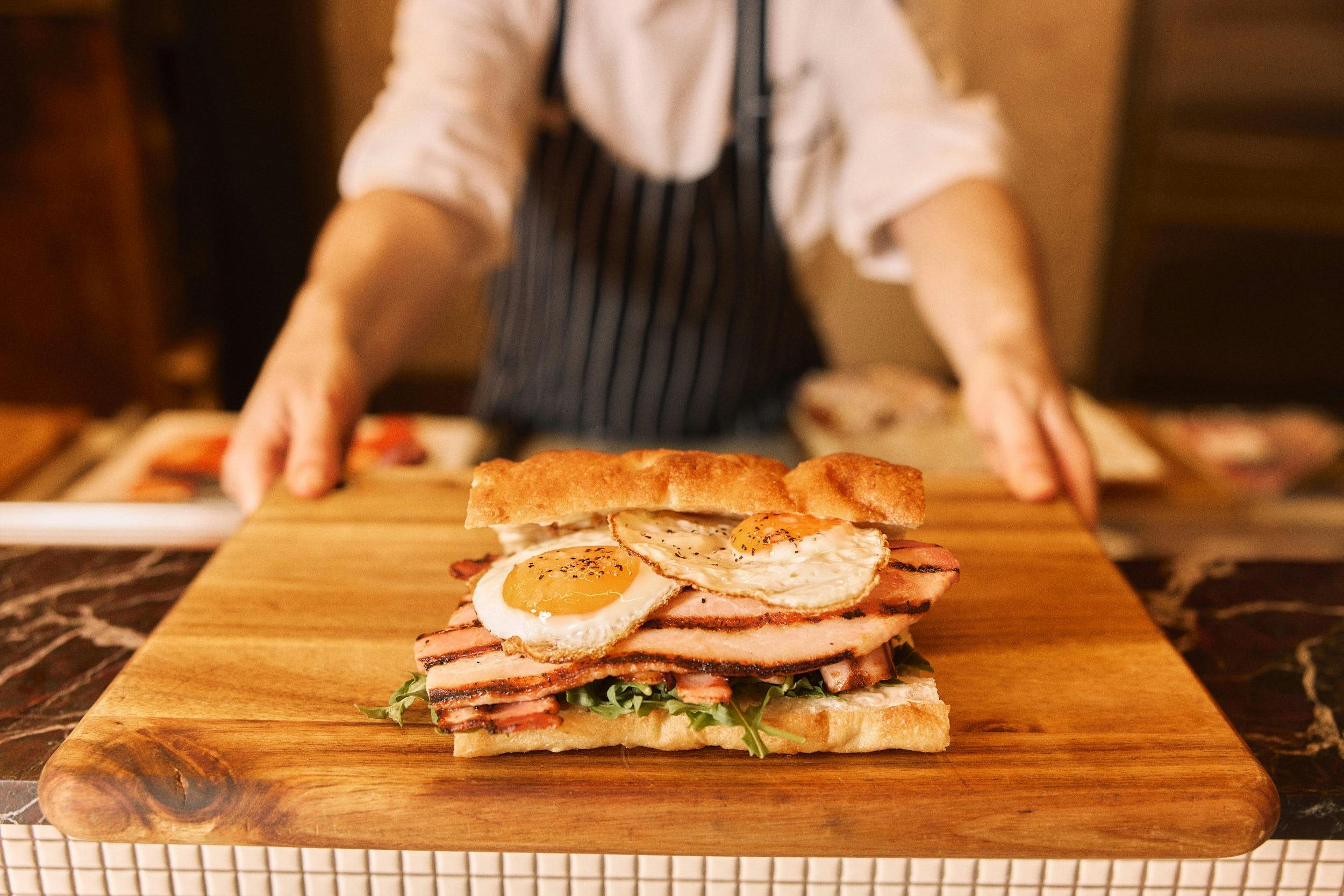 One of seven different panino options at Tessuto Sydney - the Bacon & Egg Panino w/ Rocket + Aioli