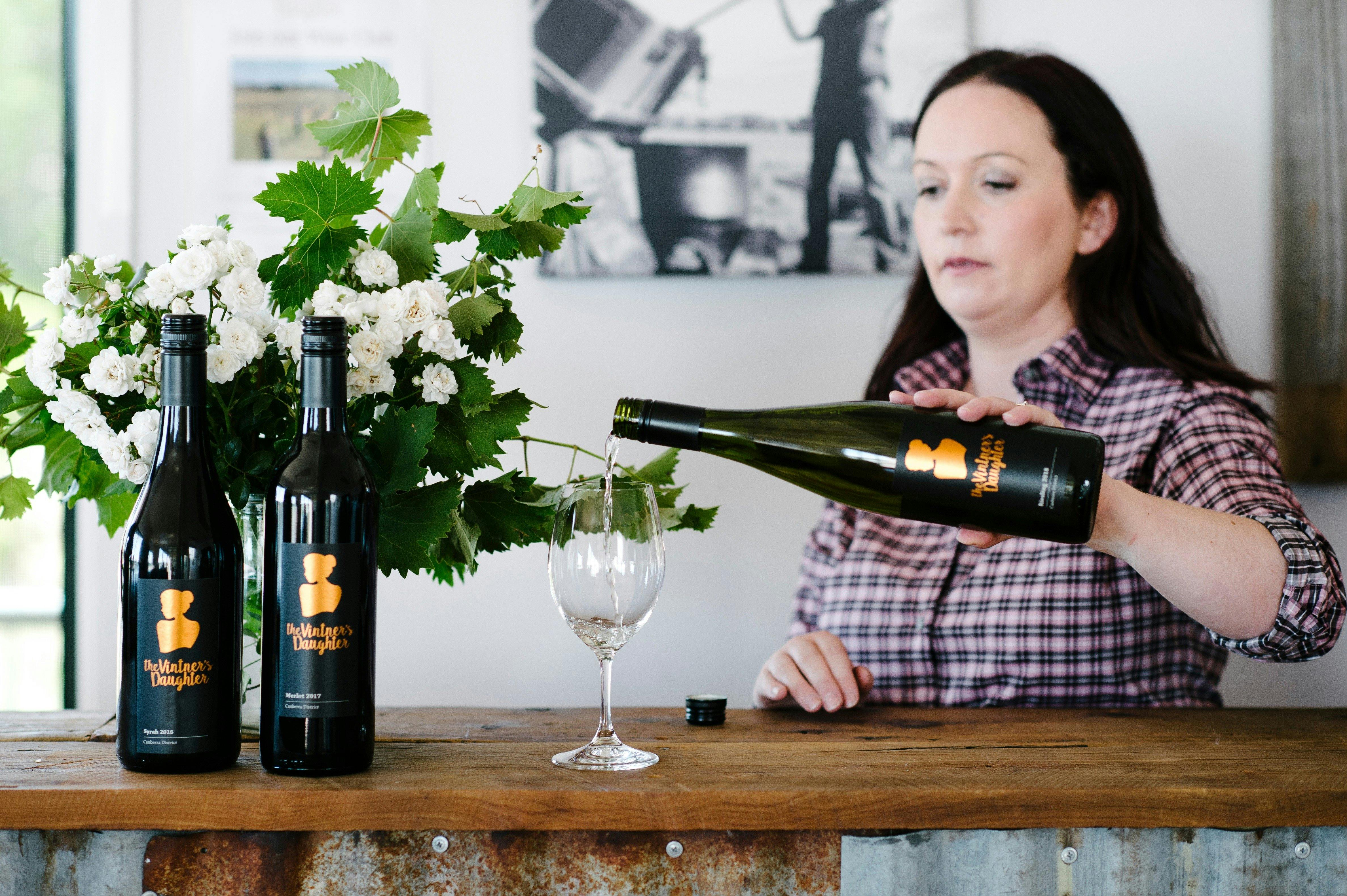 Stephanie pouring wine for tasting in the cellar door