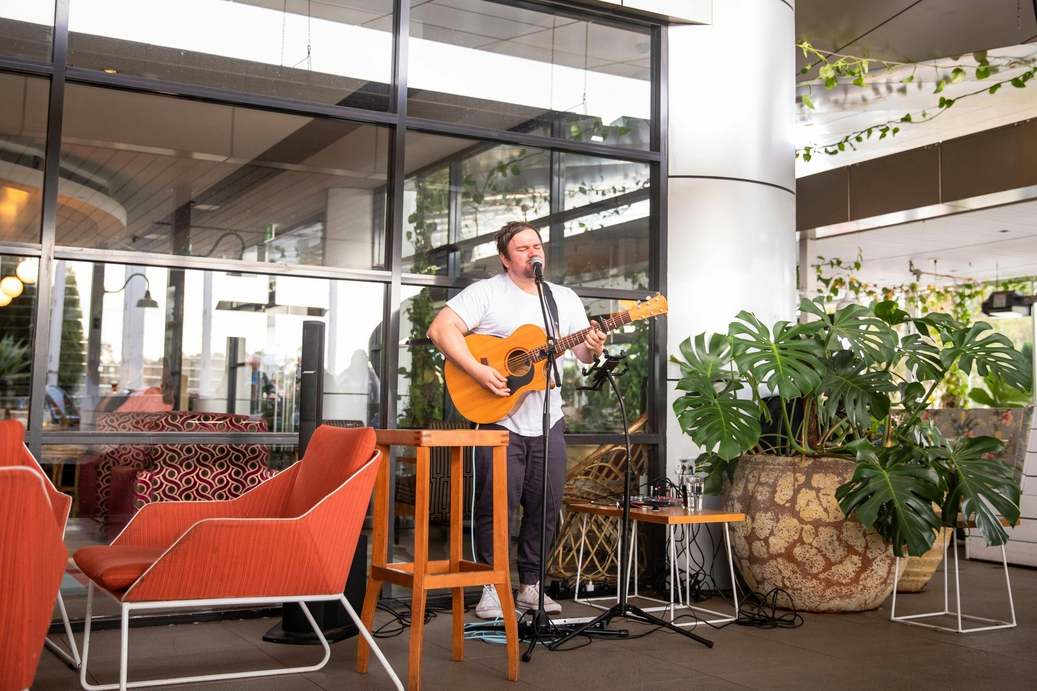 Live musician performing playing guitar at The Macarthur Tavern