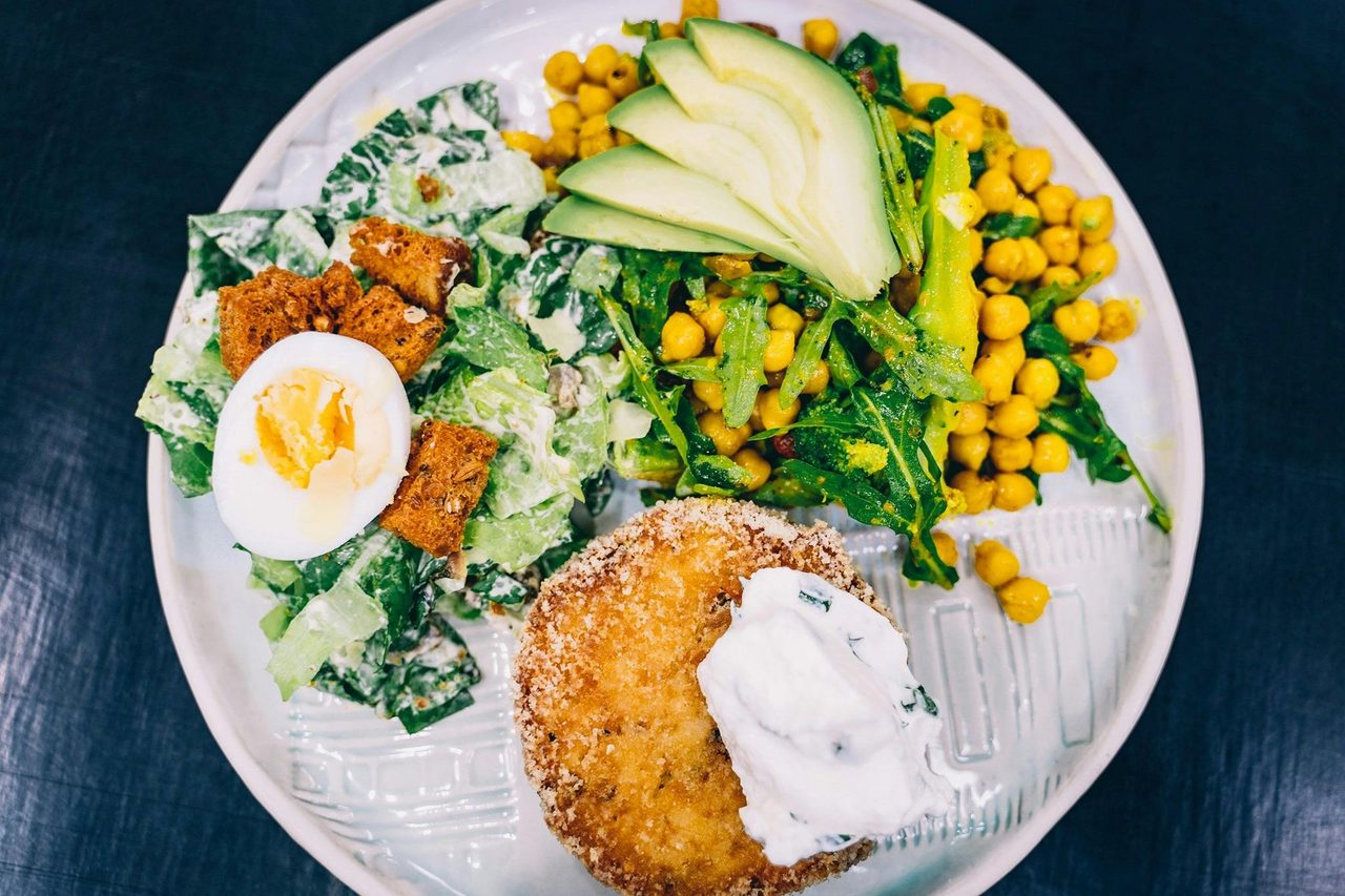 A vegetarian pattie with salad on a plate