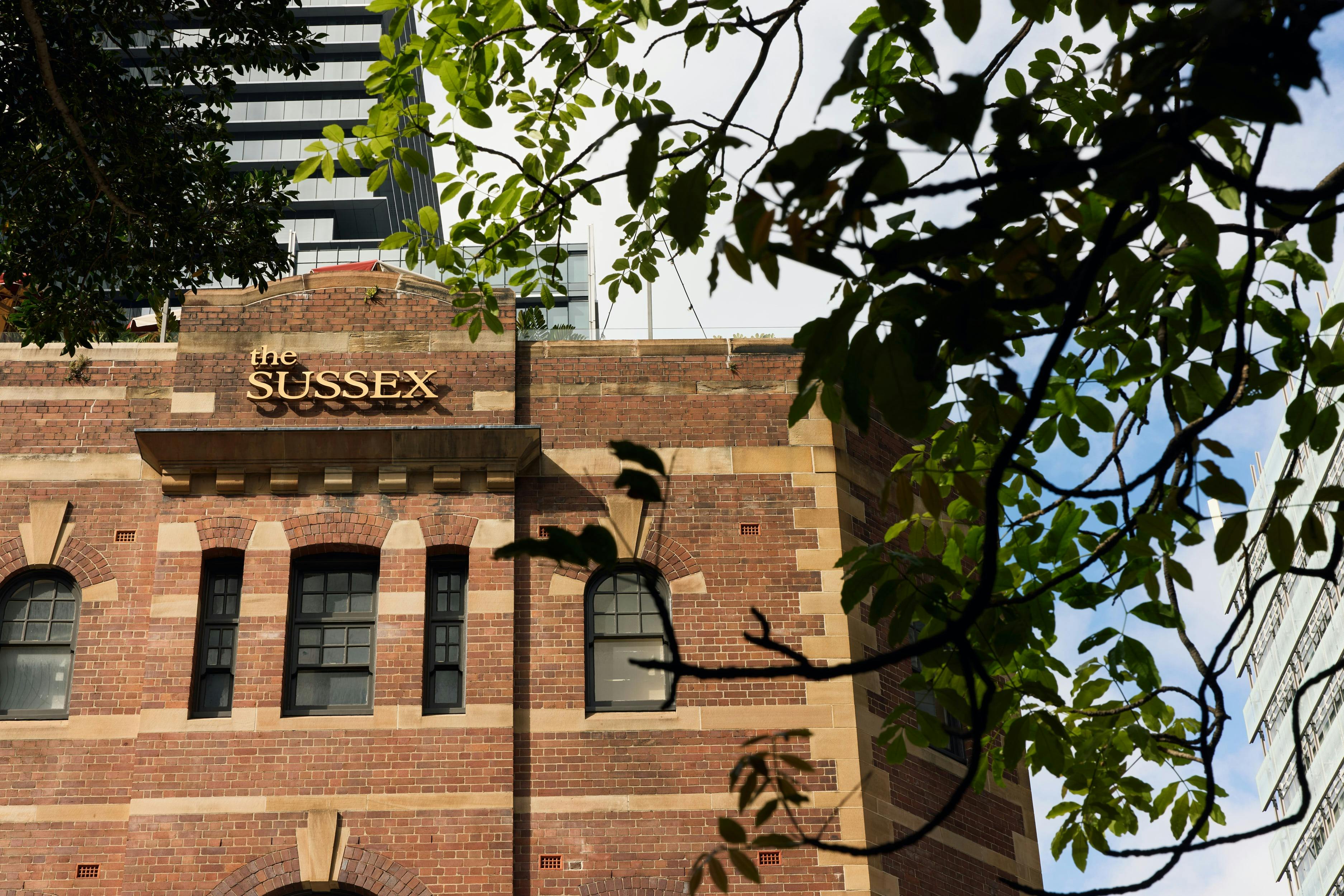 Exterior of The Sussex with greenery