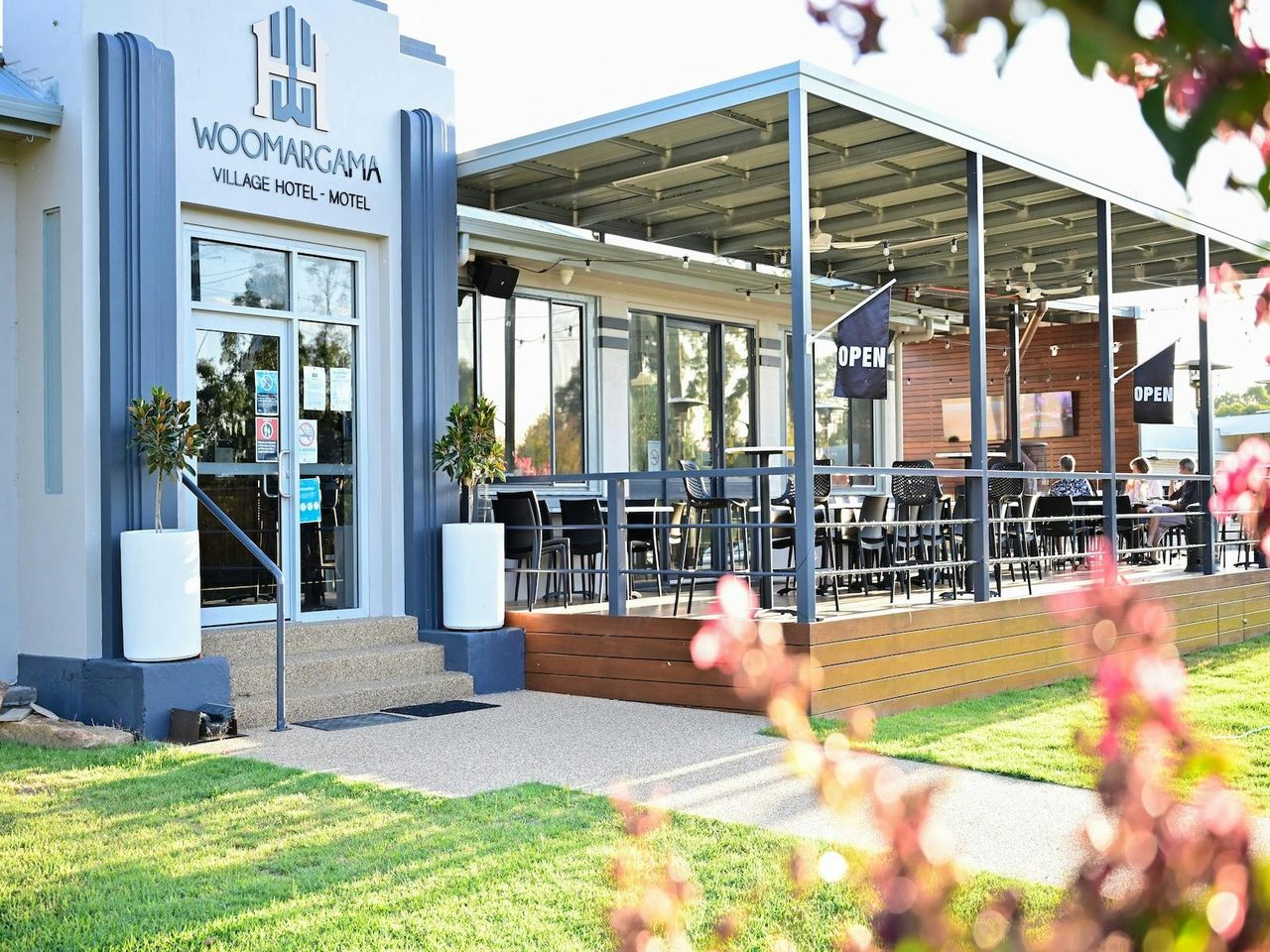 Front entrance to the Woomargama Hotel, trees and green grass.
