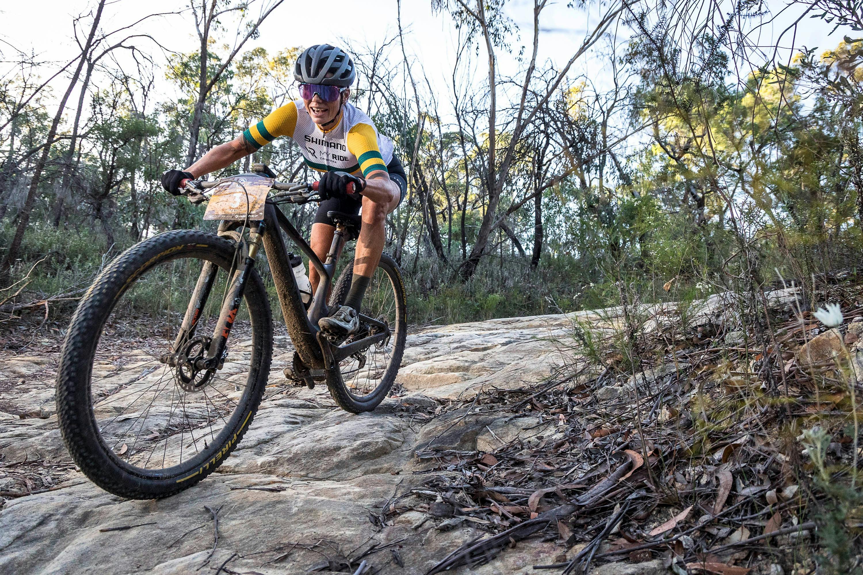 Convict 100 rider riding steep rock descent.