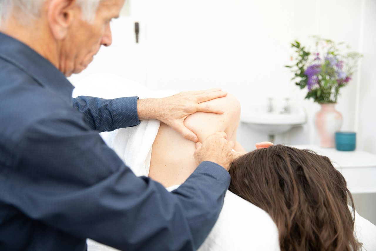 Massaging shoulder