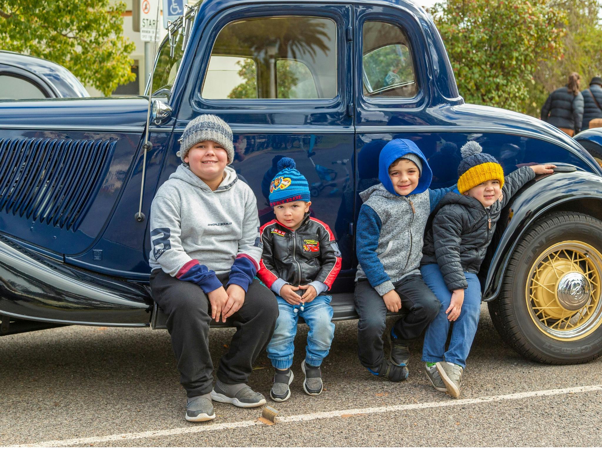 Kids enjoying the Art Deco era cars