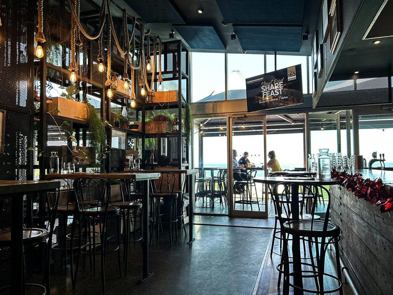 Grab a spot inside or on the balcony and soak the stunning ocean views