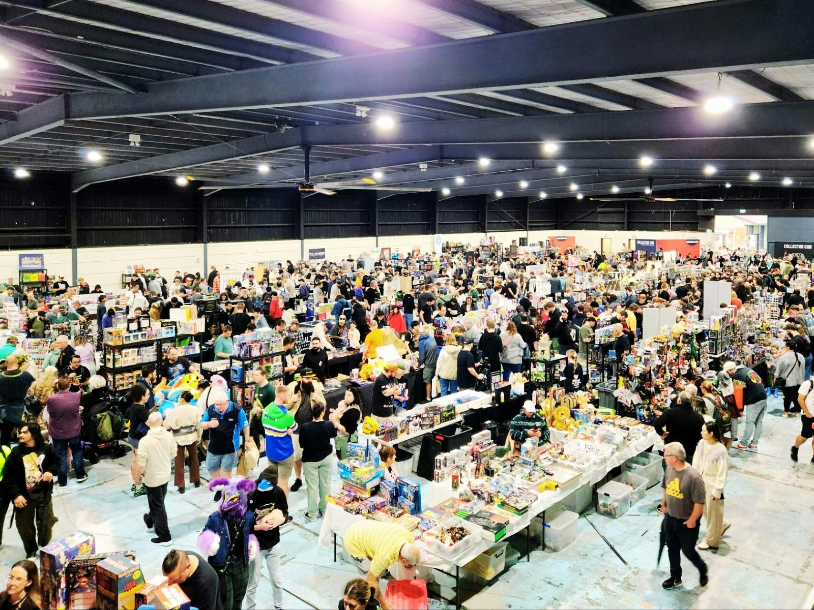 Birds eye view of vendor tables and attendees walking around Collector Con event
