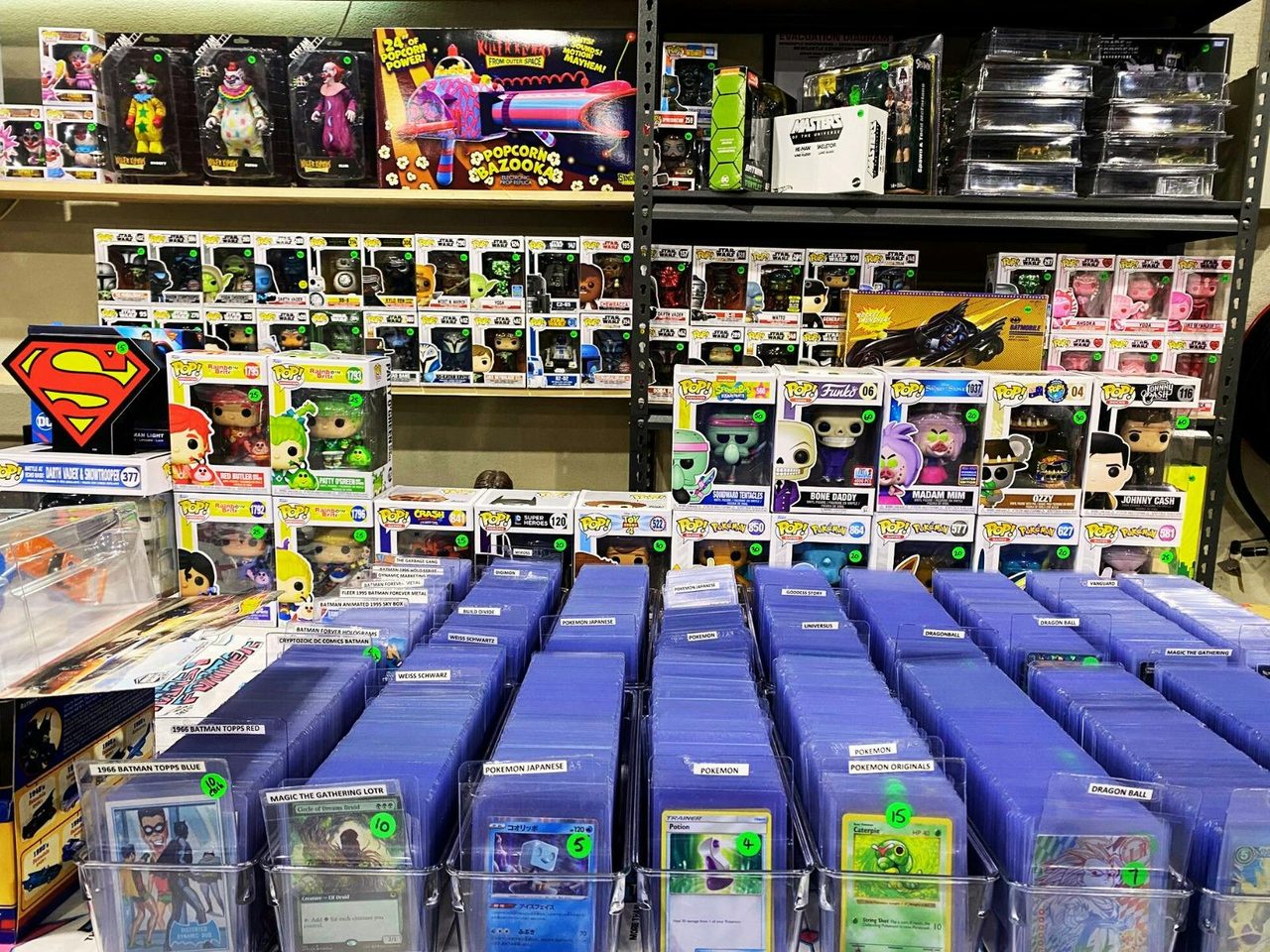 Trading cards, POPS and action figures on display at a vendor table