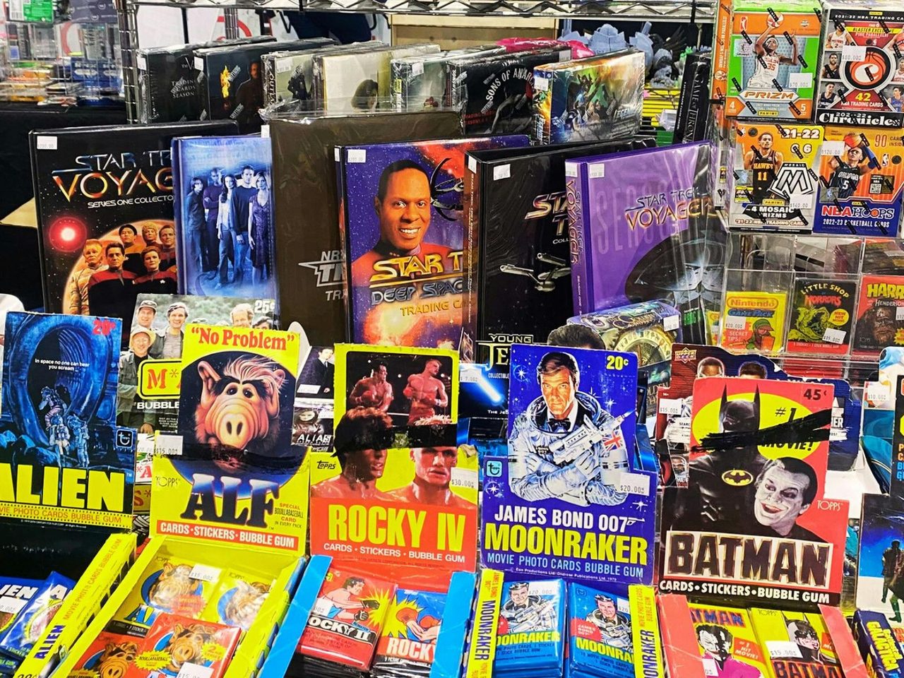 Vintage trading cards on display including movie and tv cards