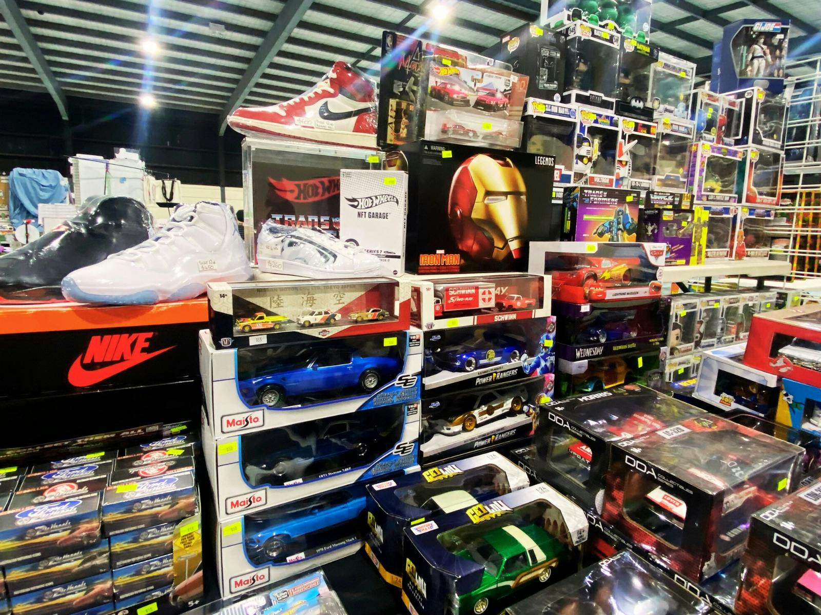 Mixed collectables on display including sneakers, cards and action figures