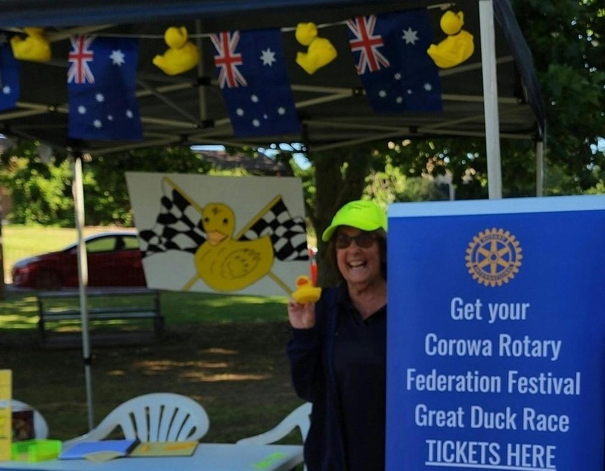 Lady holding duck and selling tickets