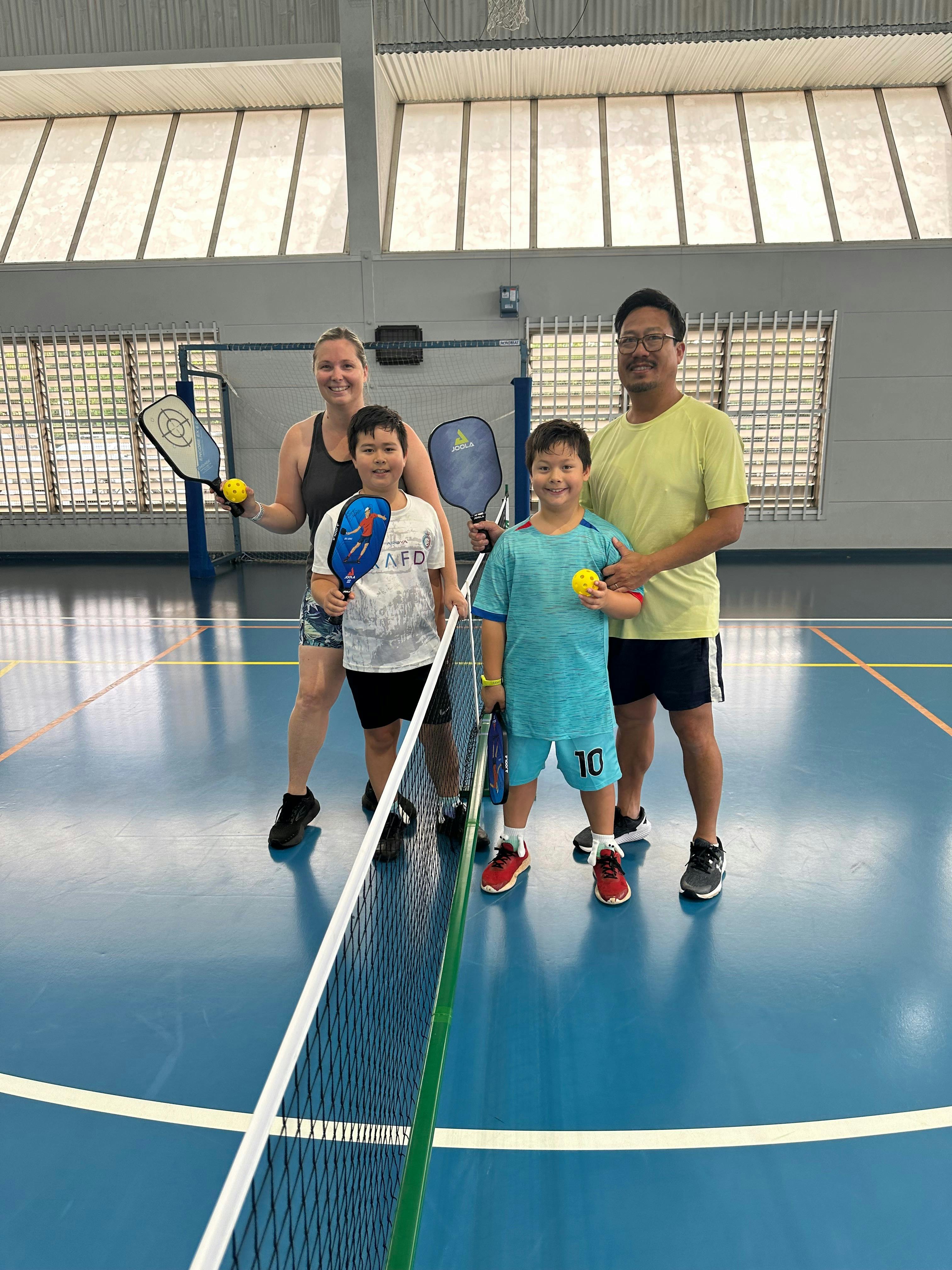 a family playing Pickleball