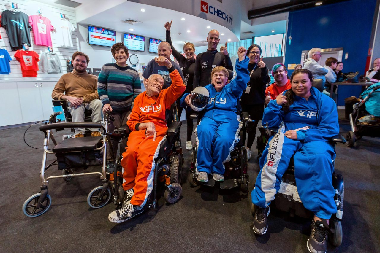 All Abilities Group in suits giving a cheer!