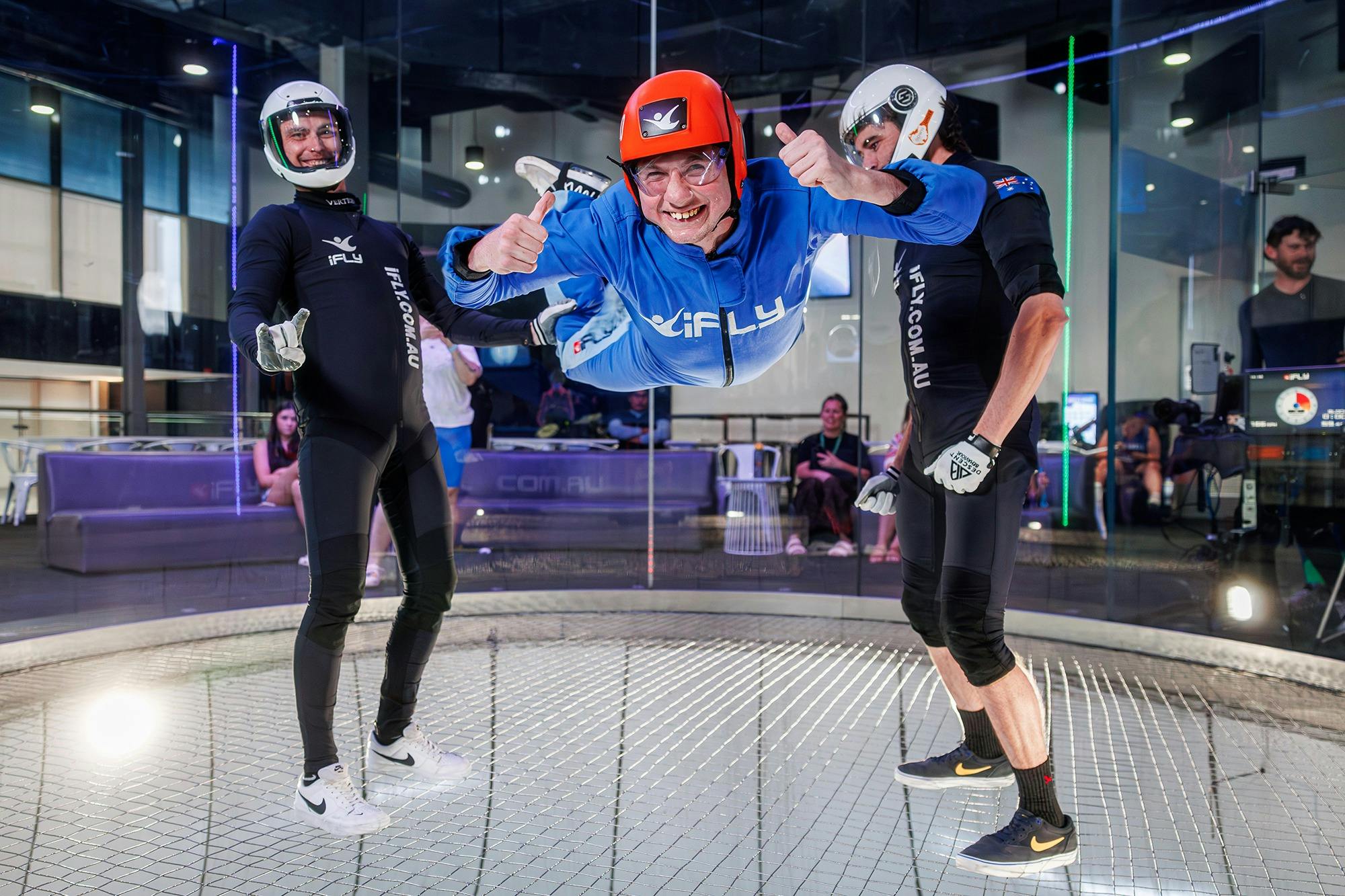 Flyer in a blue suits gives a thumbs up to the camera