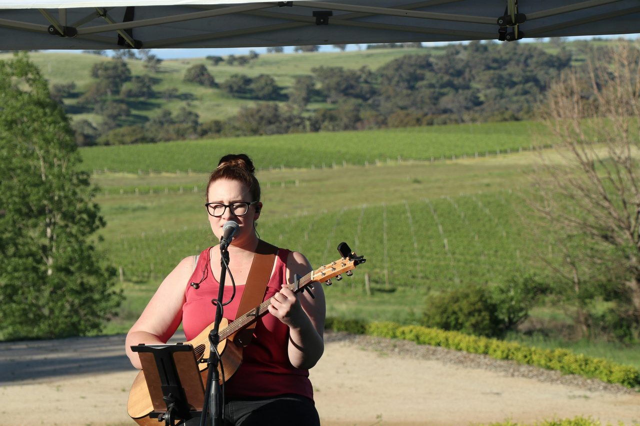 Female signer in the vineyards at Stockman's Ridge Wines