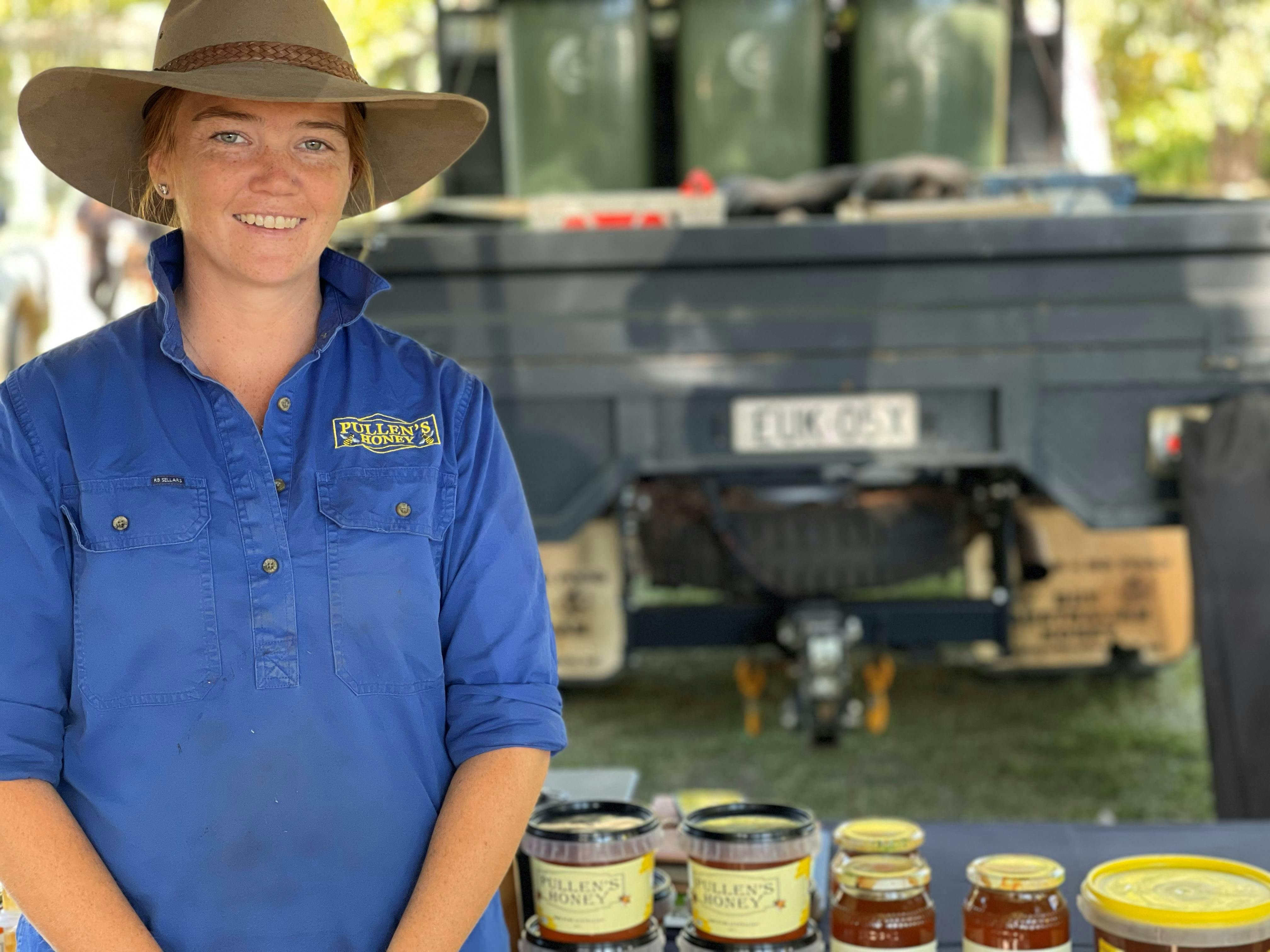 woman beside table of honey