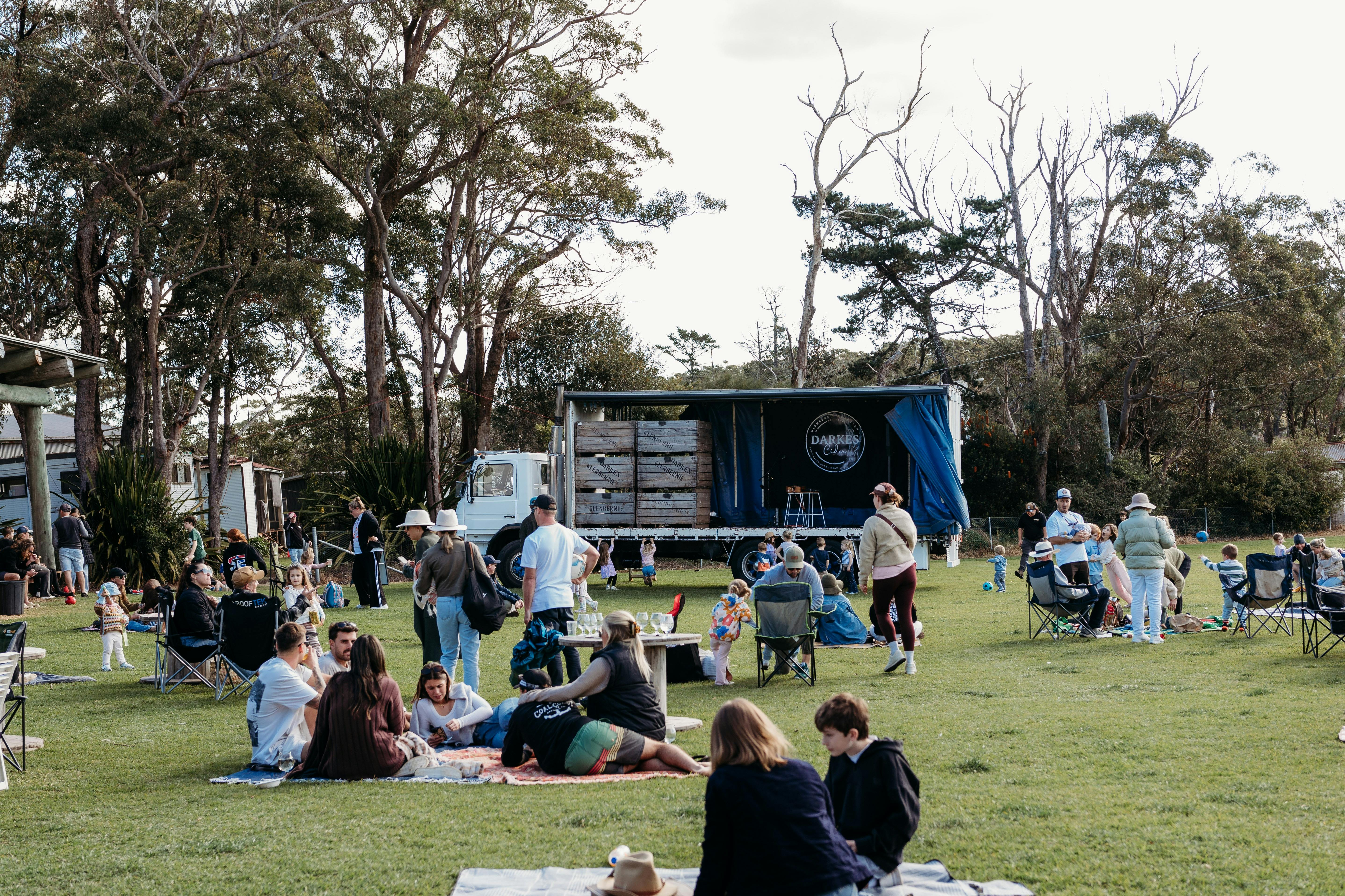 Picnickers enjoying set up in paddock near band stage