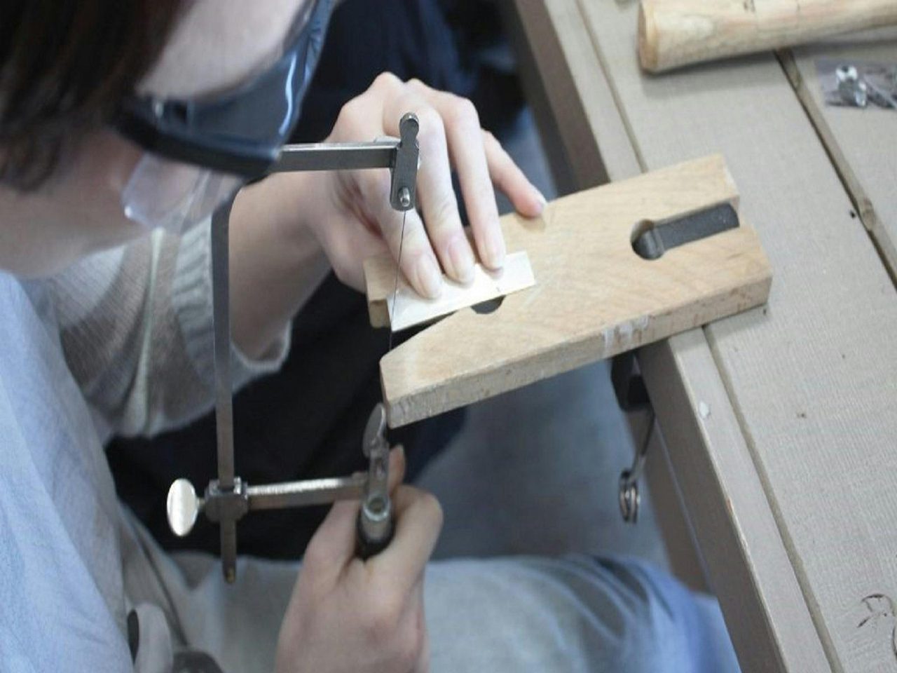 Sawing out the metal for a ring