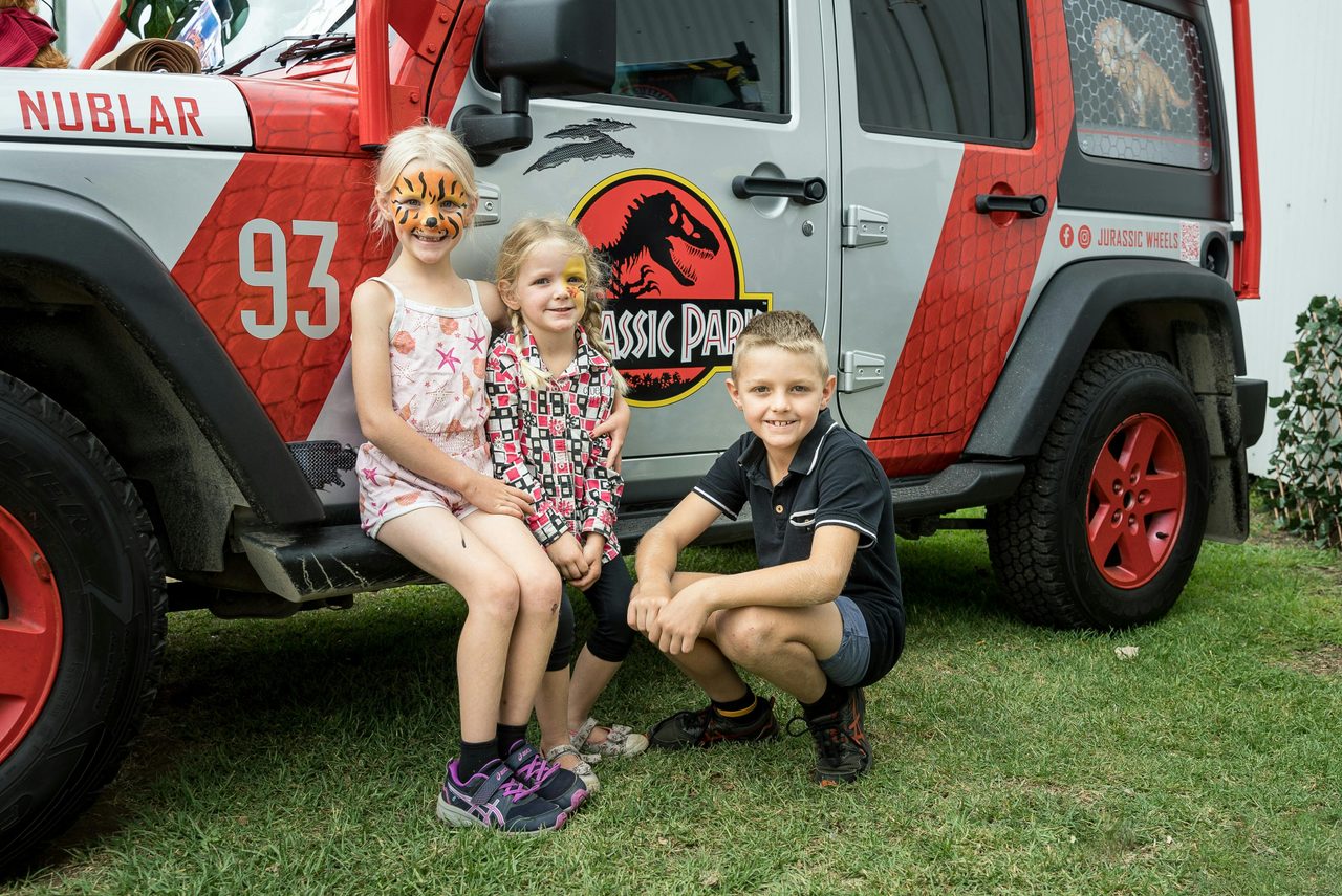 Kids at Minerama in front of Jurassic Park themed jeep