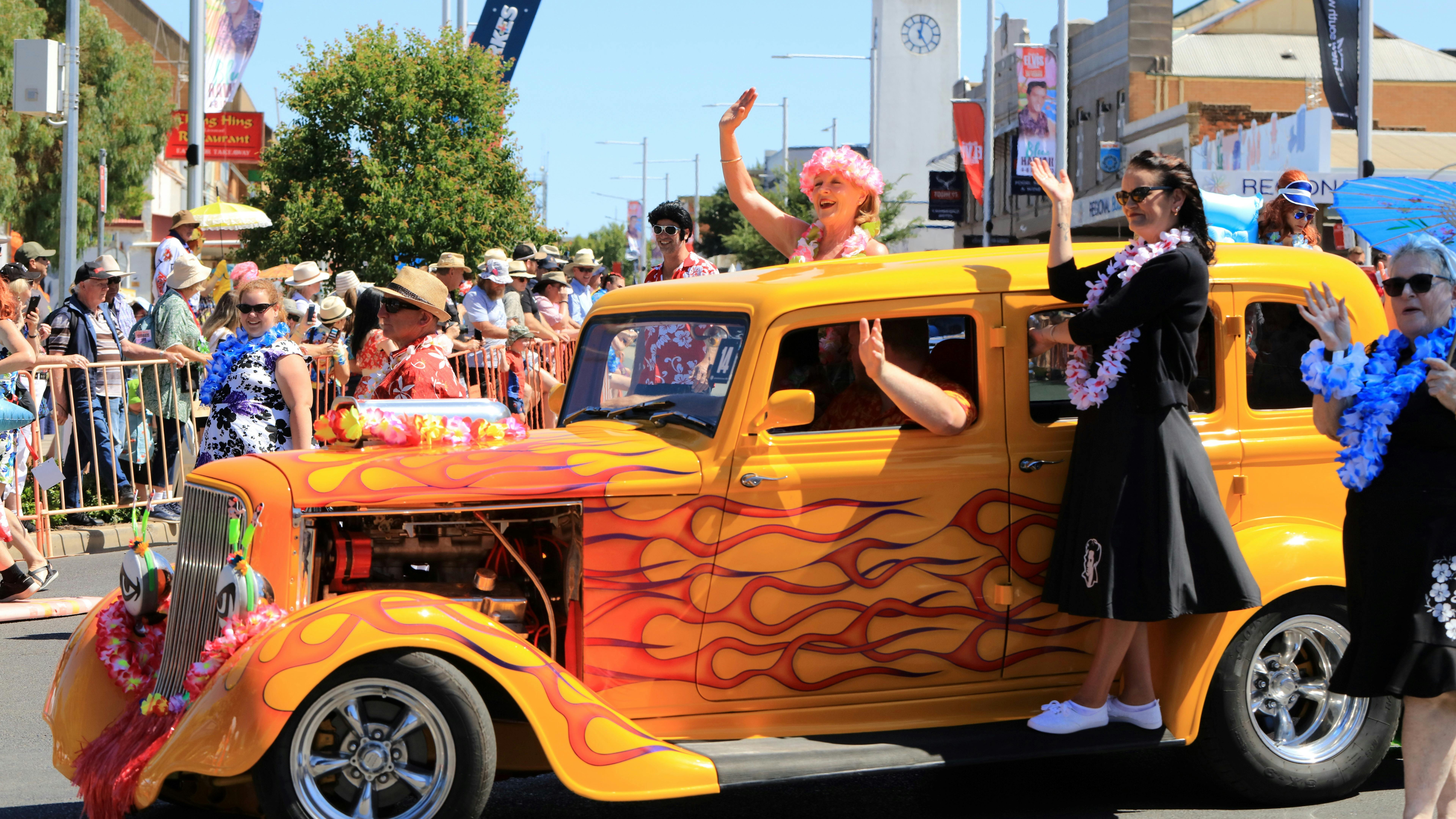 Vehicle is street parade with people