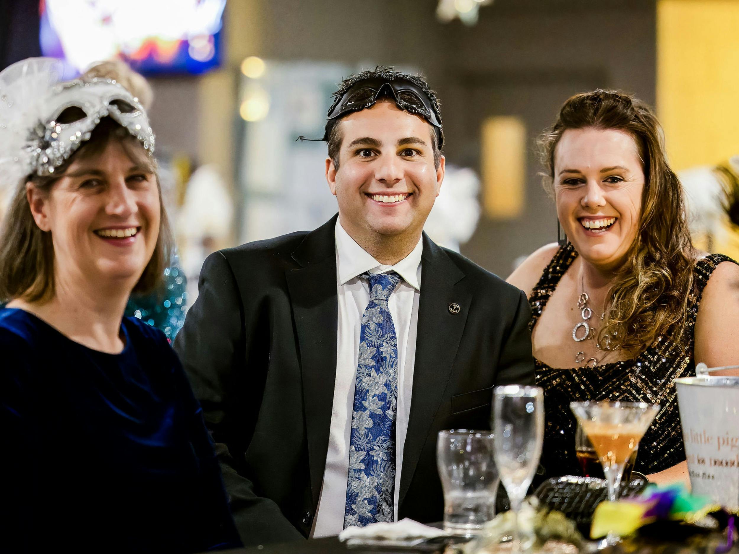 Three people smiling at the Jindabyne Snow Ball
