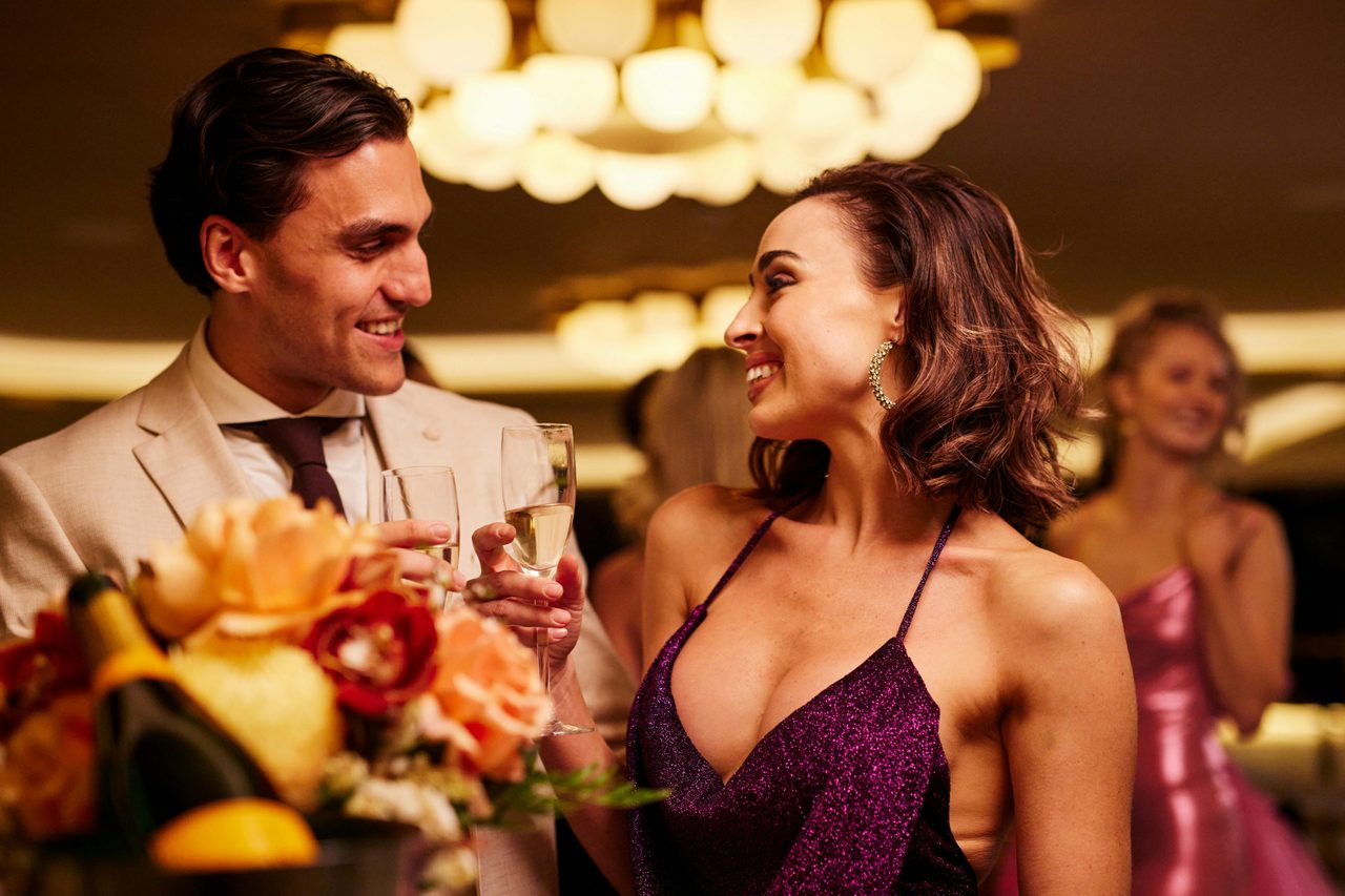Couple celebrating with glasses of Champagne