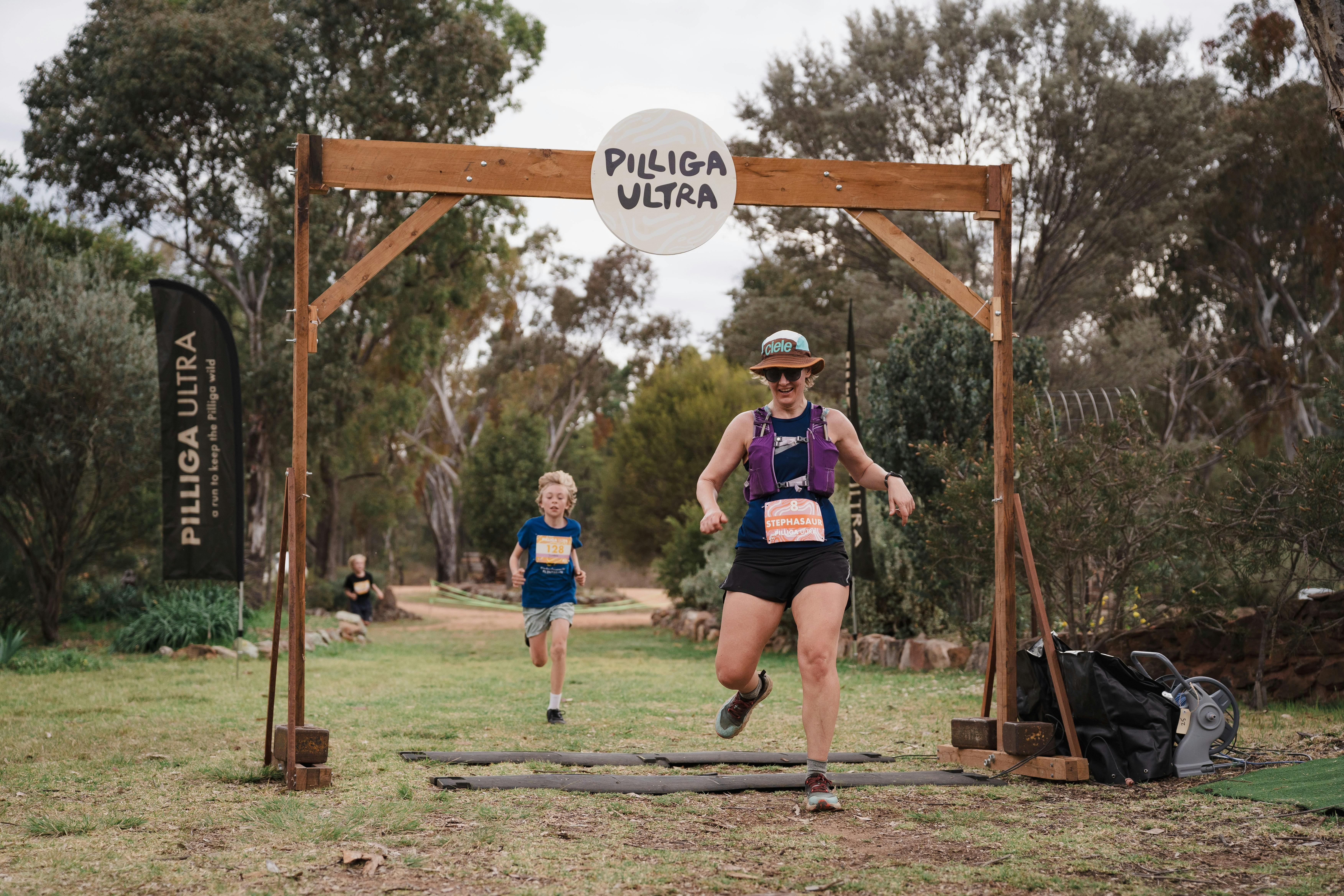 Runners cross the finish line at the end of the Pilliga Ultra