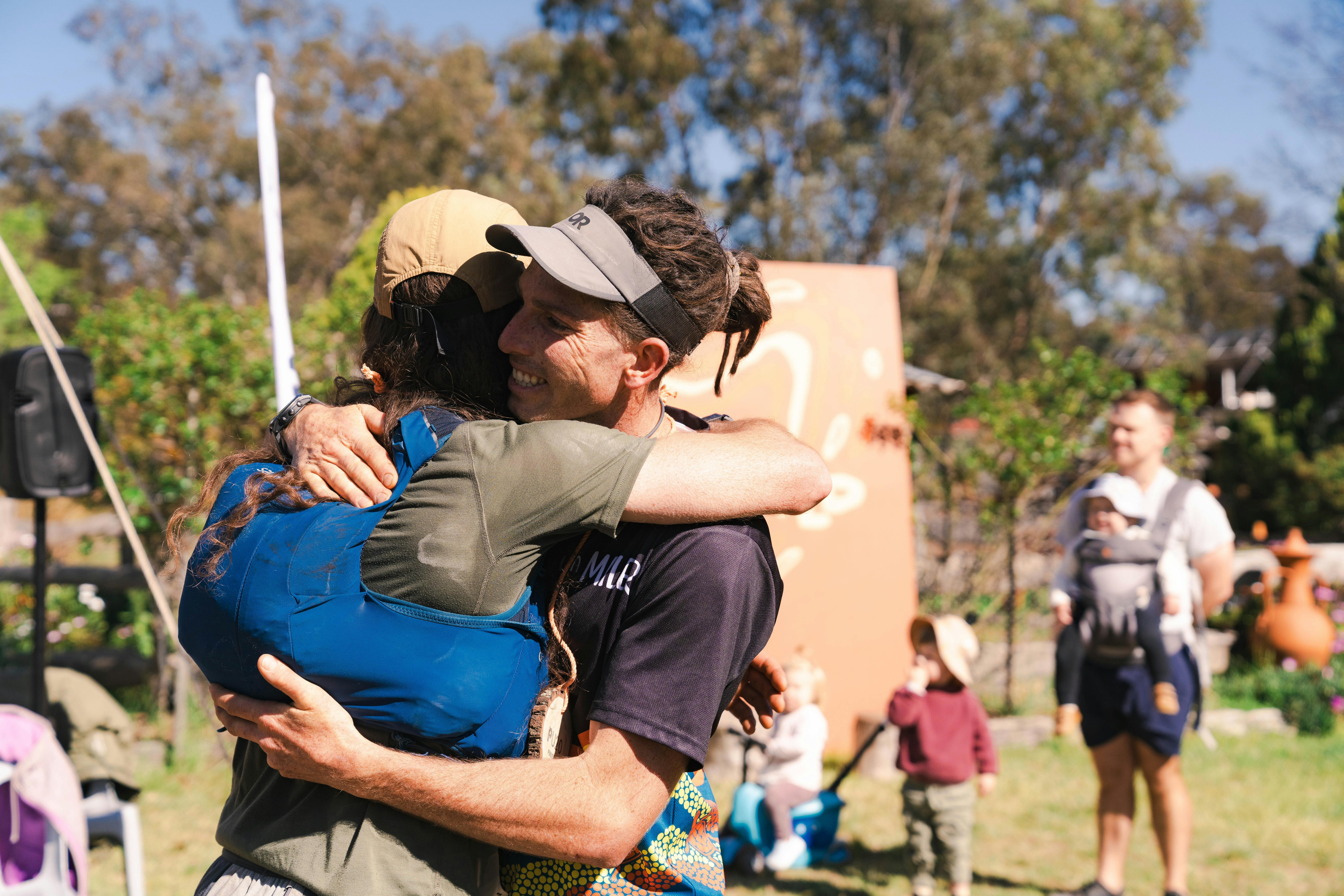 Two runners embrace at the finish line of the Pilliga Ultra