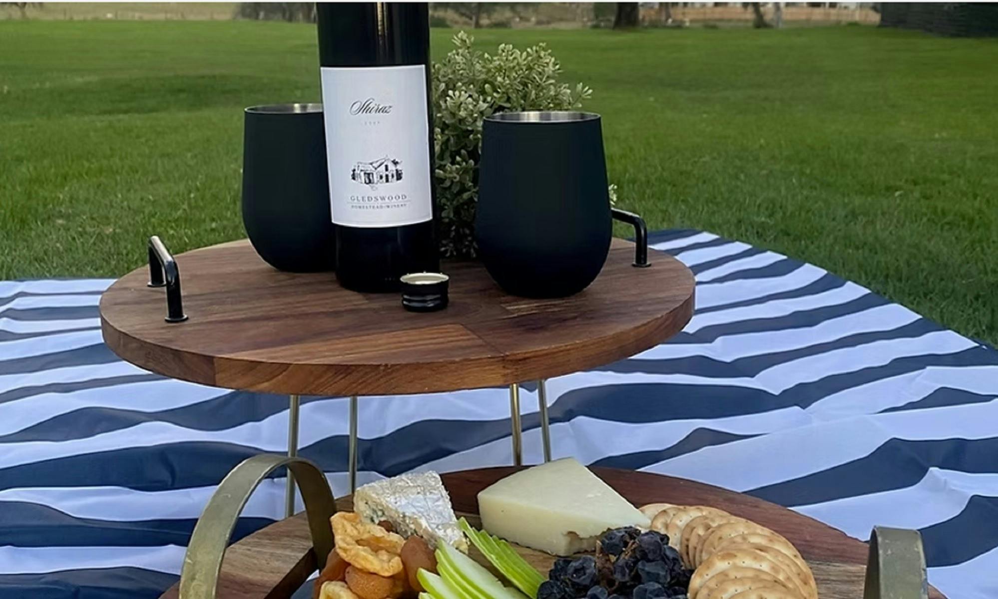 Wine bottle with Cheese platter on lawn