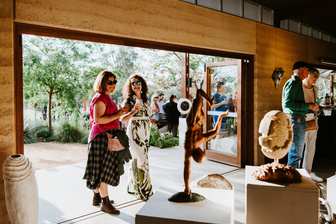 Visitors enjoying the smaller sculptures at Sculptures in the Garden
