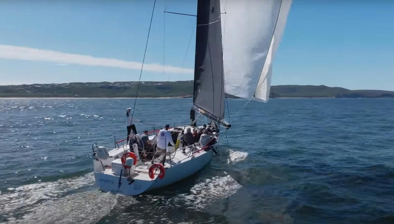 Sailing boat with people on board sailing
