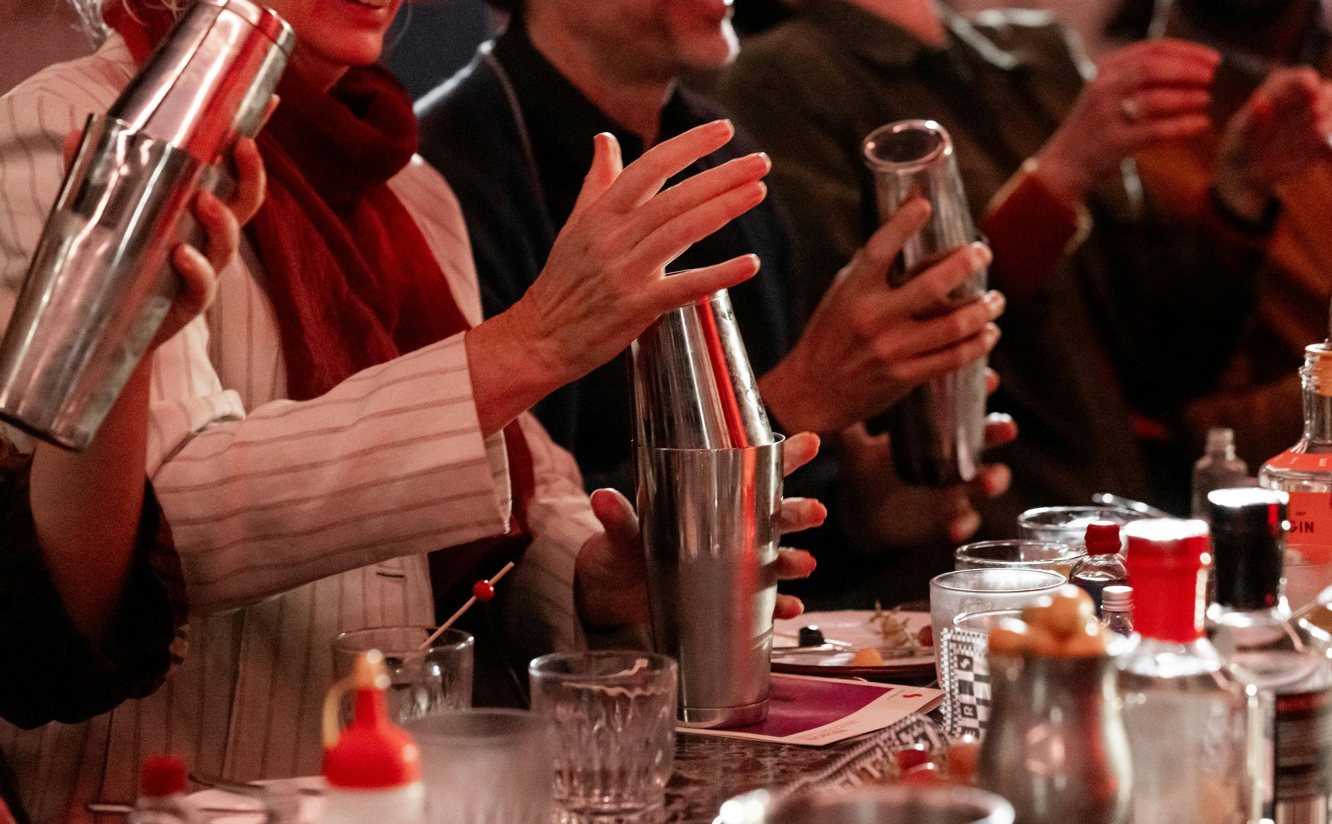 Class attenders shake cocktails