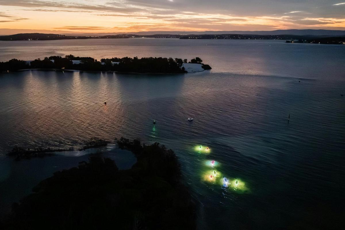 Night kayaking group near sand islands