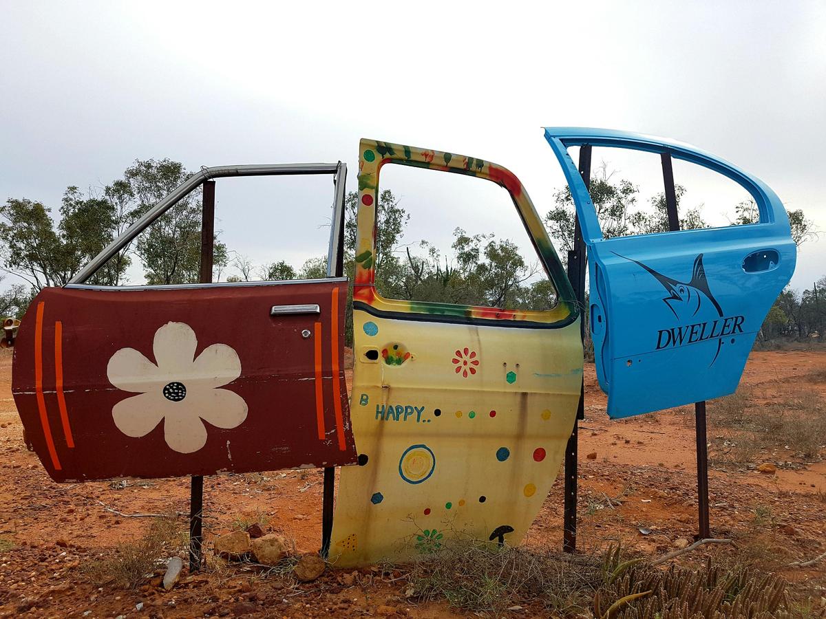 Car door tour signs in Lightning Ridge