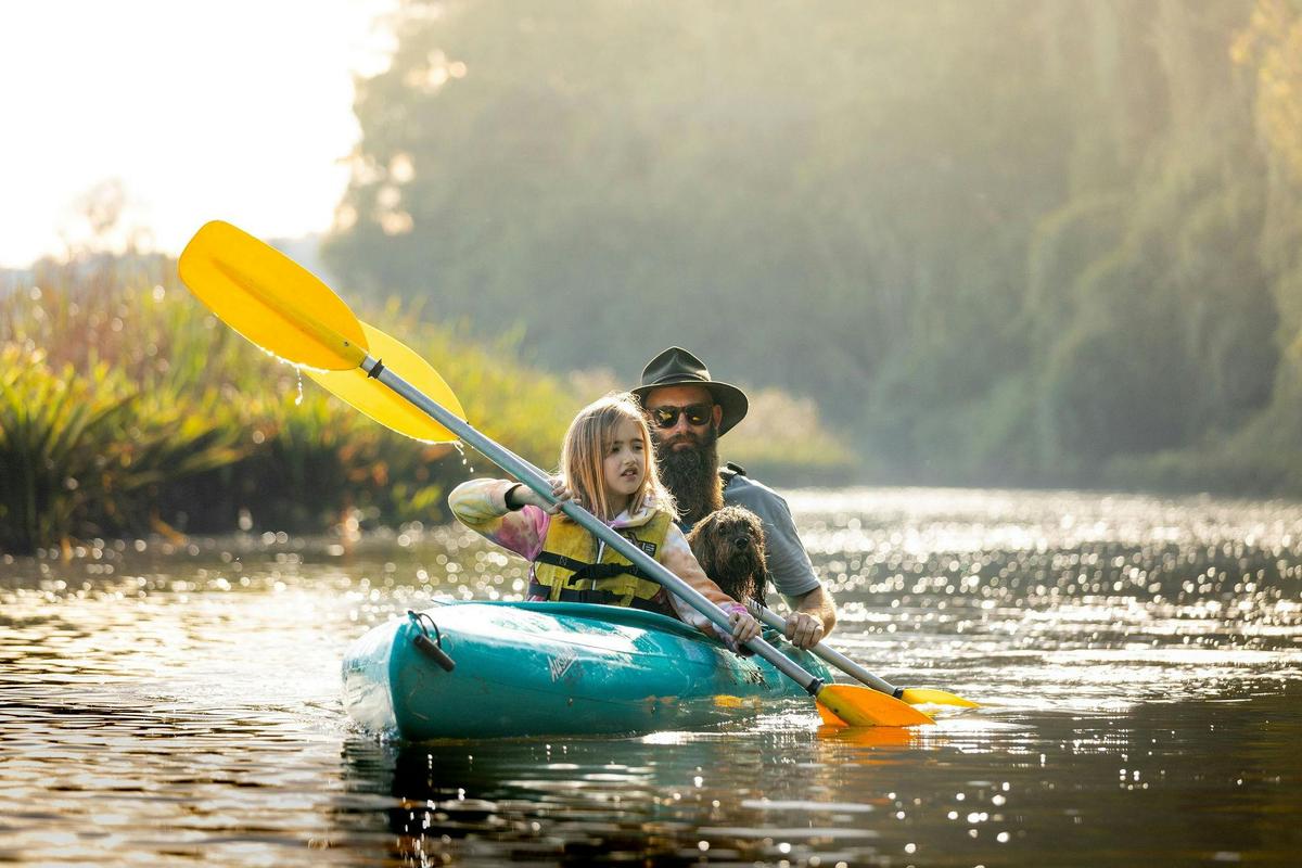 Family paddling together on the Bellinger River with Bellingen Canoe Adventures