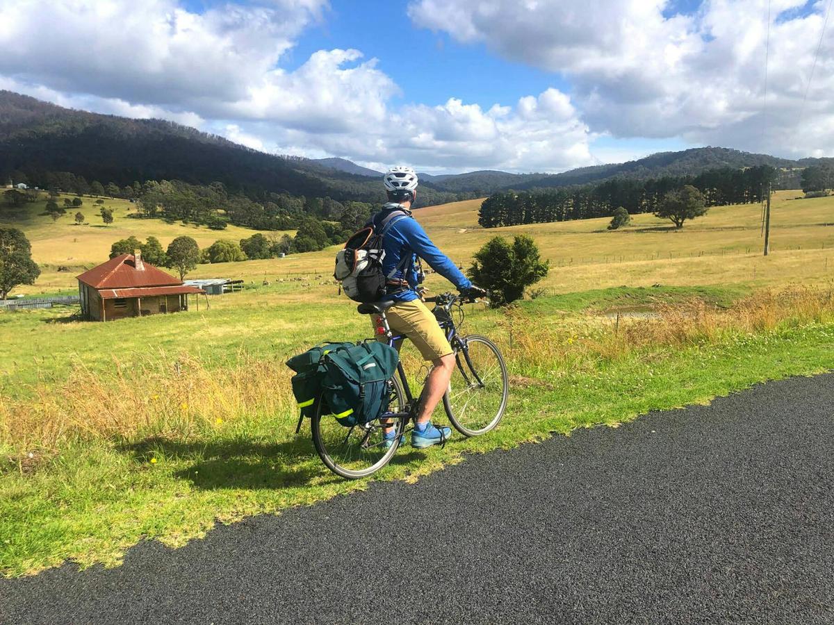 Cyclist taking in the beautiful rural scenes on Myrtle Mountain Road.
