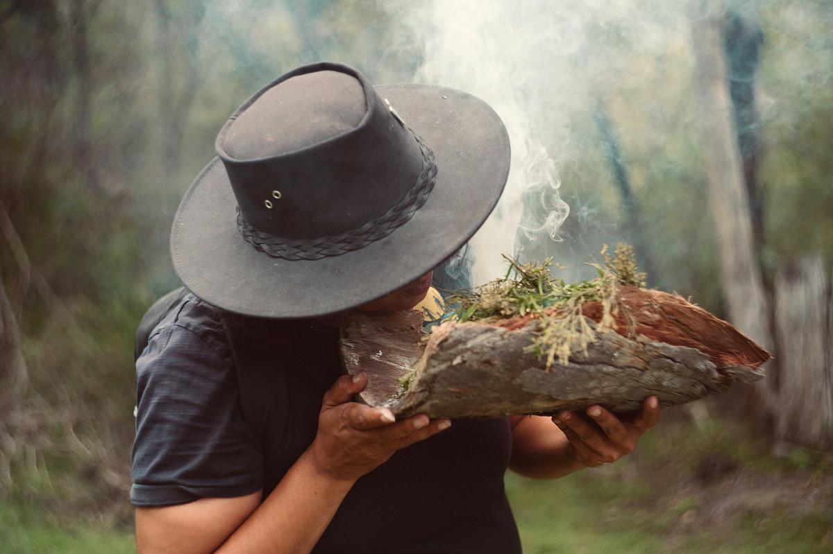 Lead Your Guide performing the start of a smoking ceremony
