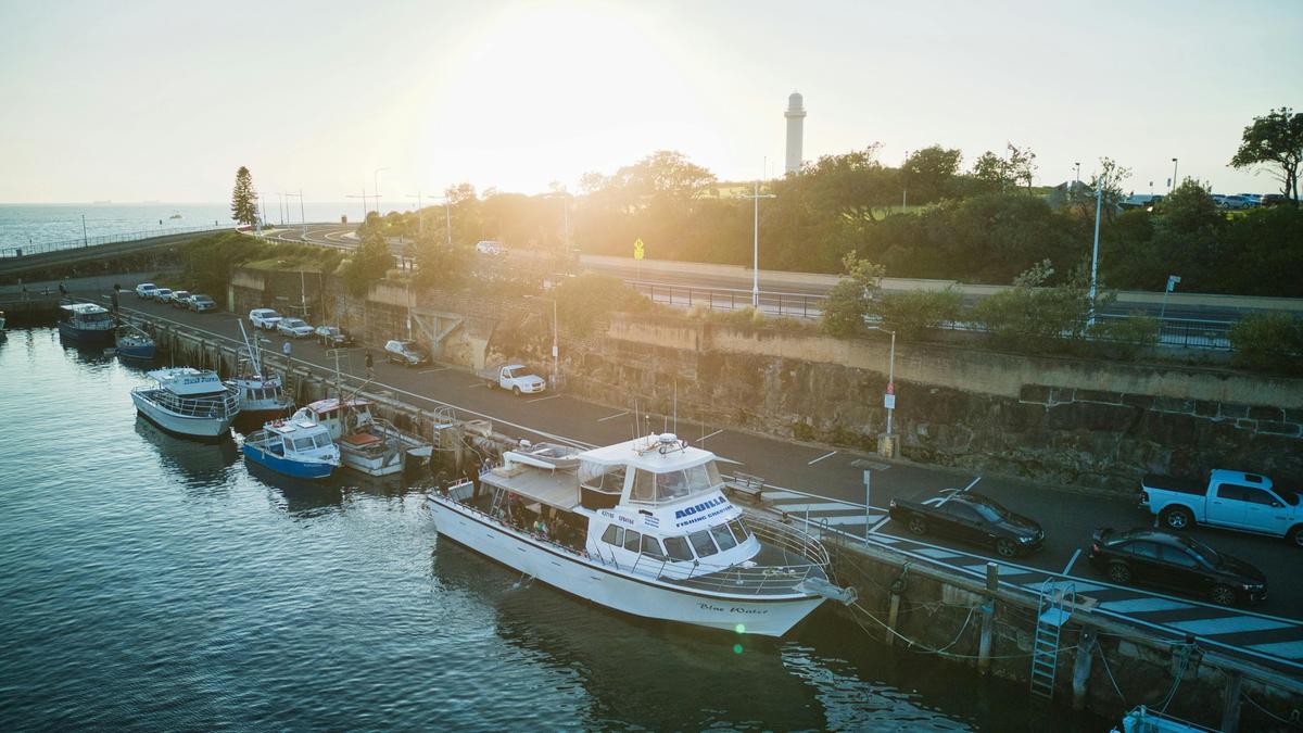A wide shot of vessel against a sunrise background