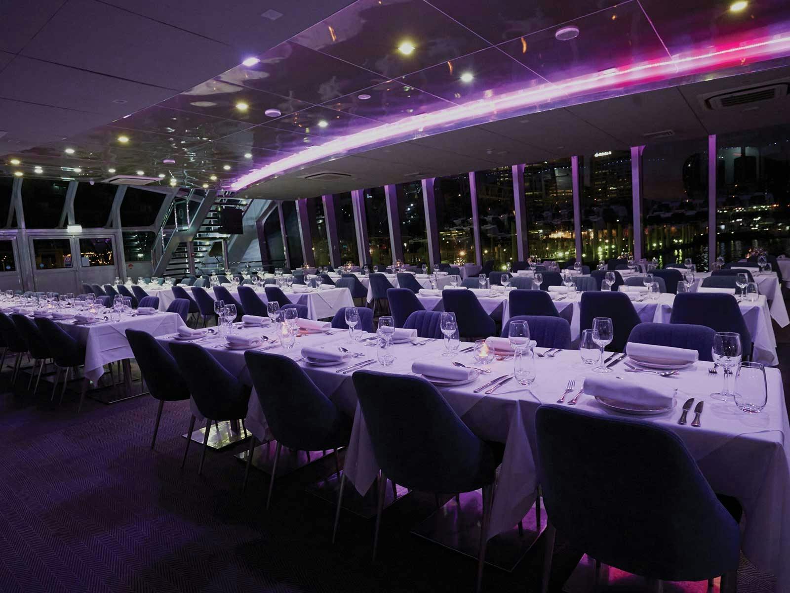 The glass-wrapped dining saloon of Clearview Glass Boat on Sydney Harbour