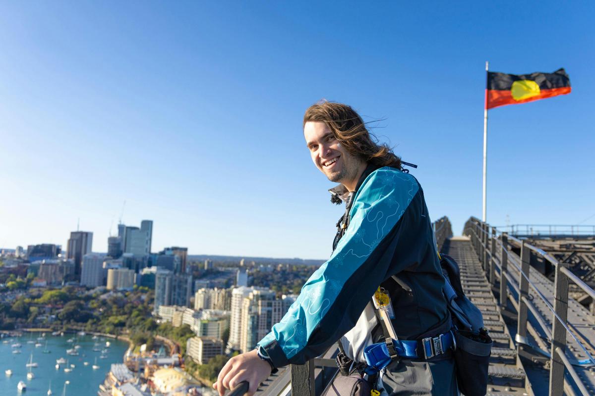 Climb Leader at Summit of Bridge with Aboriginal Flag, BridgeClimb