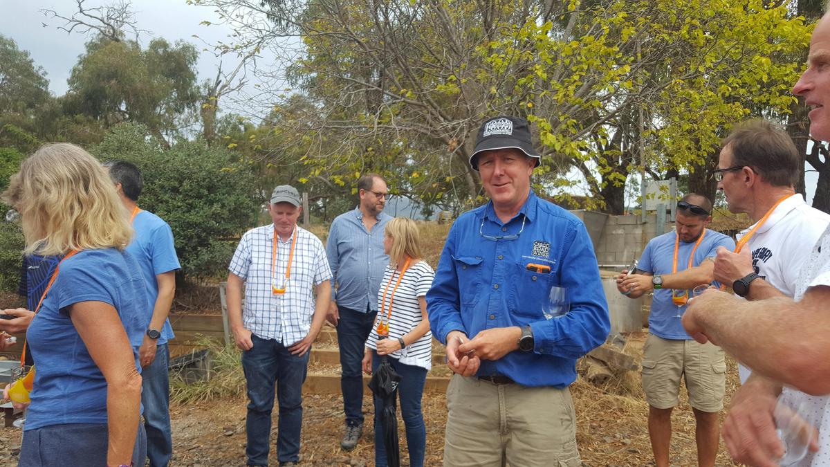 guiding a group of people around a winery