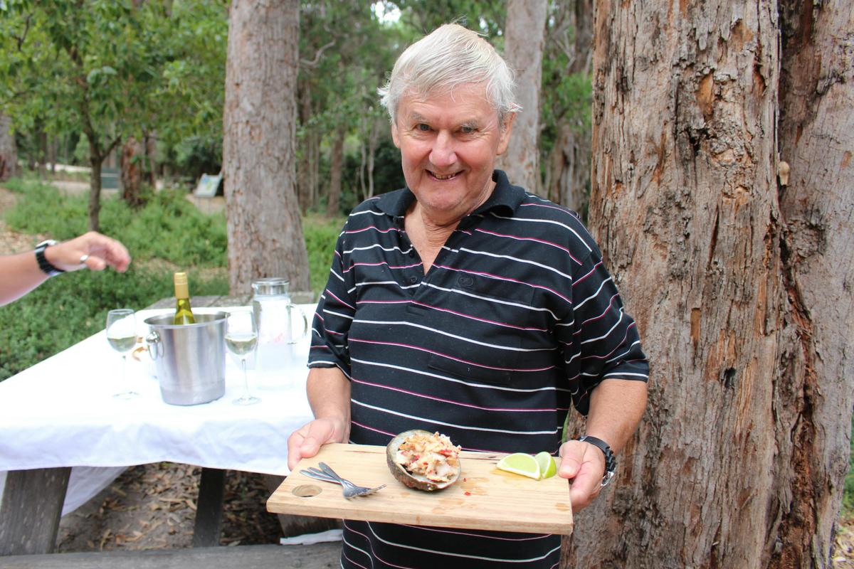 Guest holding freshly prepared abalone collected moments beforehand.