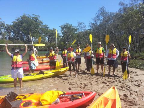 Rel;axing on the shore after kayak leg with C-Change Adventures