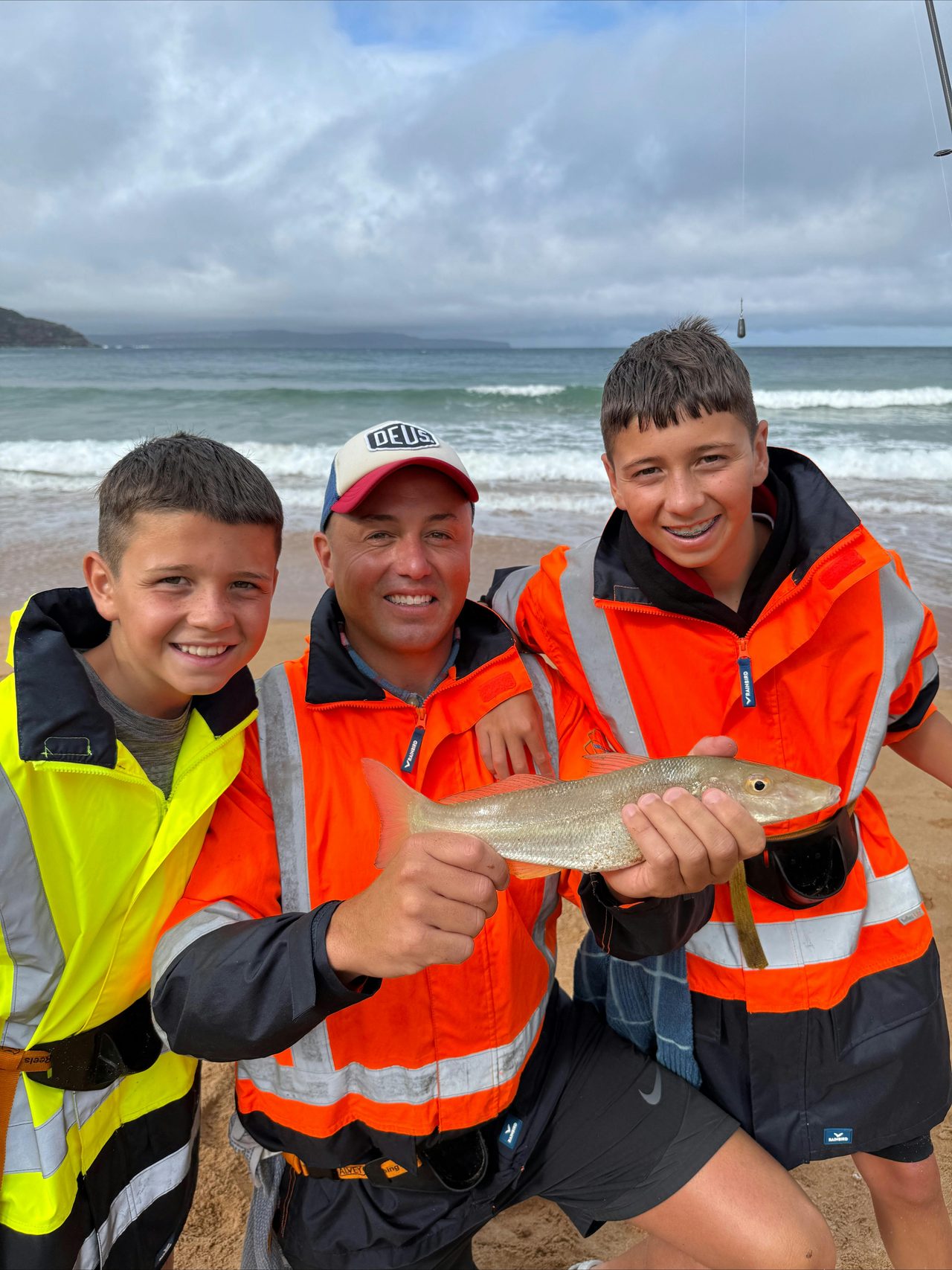 father and sons beach fishing trip.