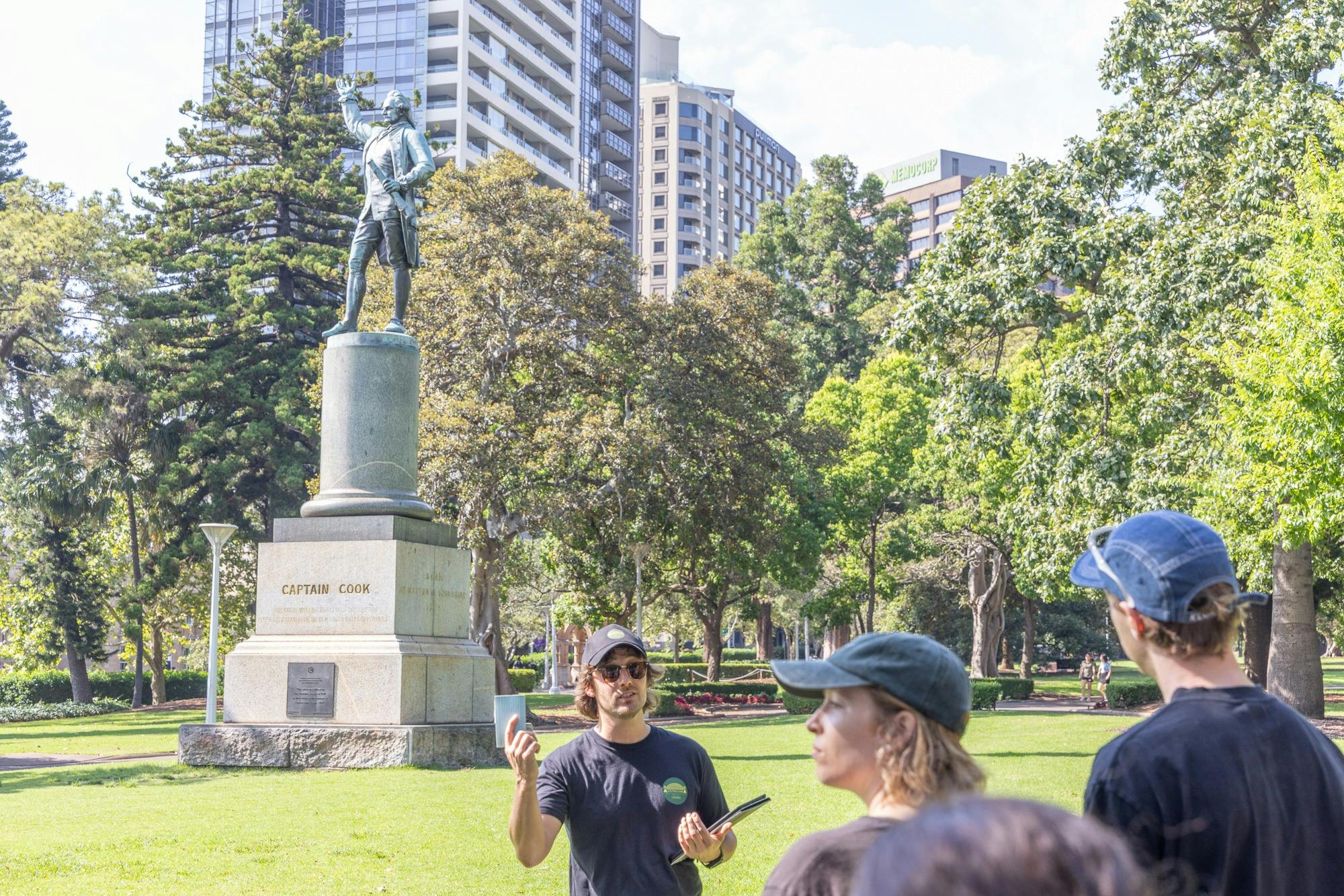 Tour Guide discussing Captain Cook in Hyde Park in front of his statue