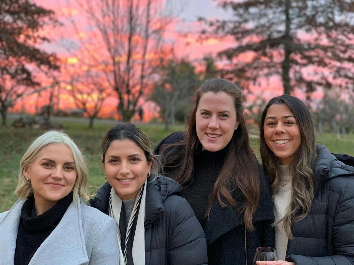 4 ladies standing in front of sunset