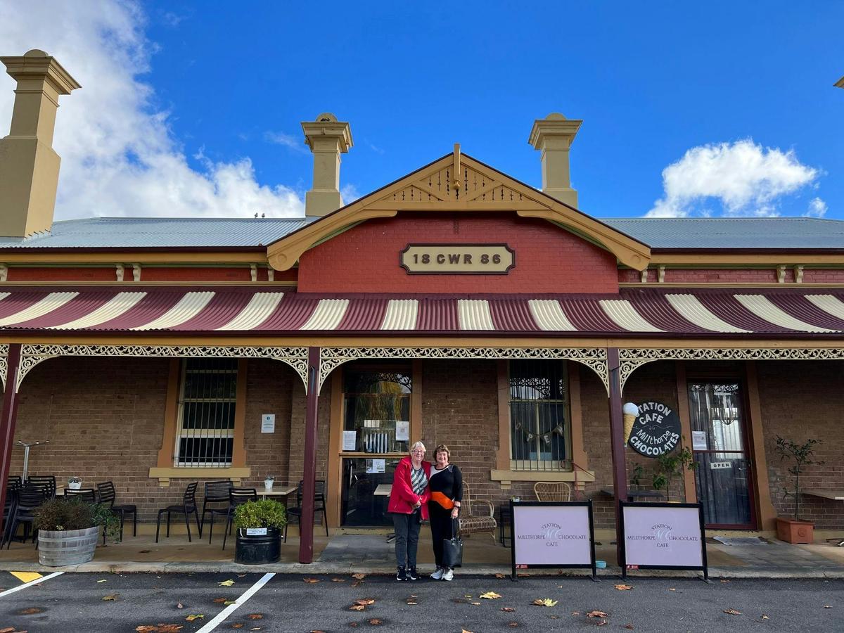 2 ladies standing in front of Millthorpe railway station