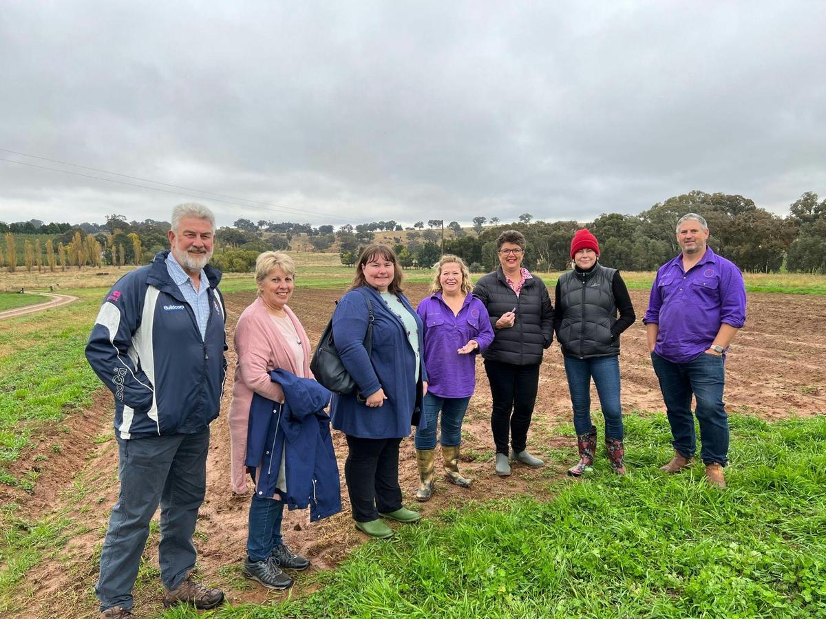 7 people standing in paddock on cold winter morning