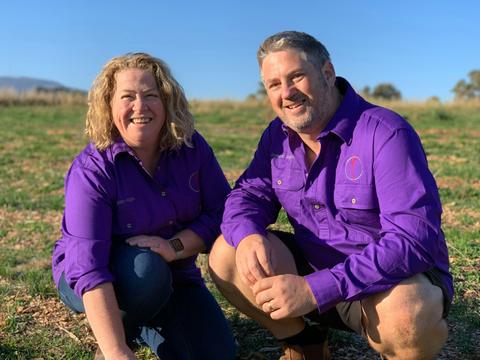 2 people kneeling in saffron field